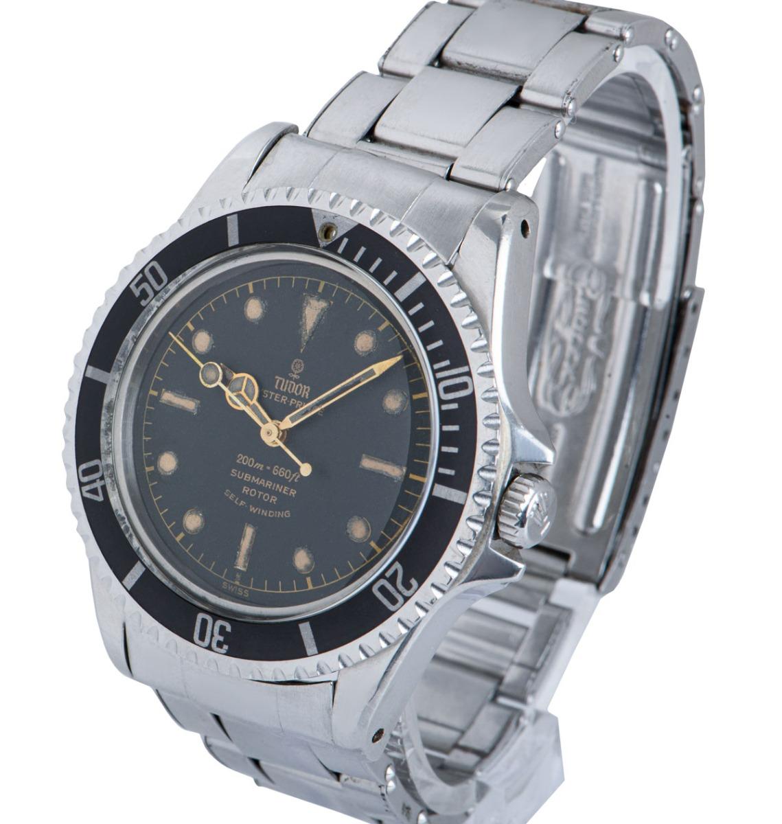 This 40 mm vintage stainless steel Submariner is potentially the most classic sports model from Tudor. Features a black dial with a gilt track, gilt writing and an exclamation dot directly below the main hour marker at 6 o'clock. The dot was brought