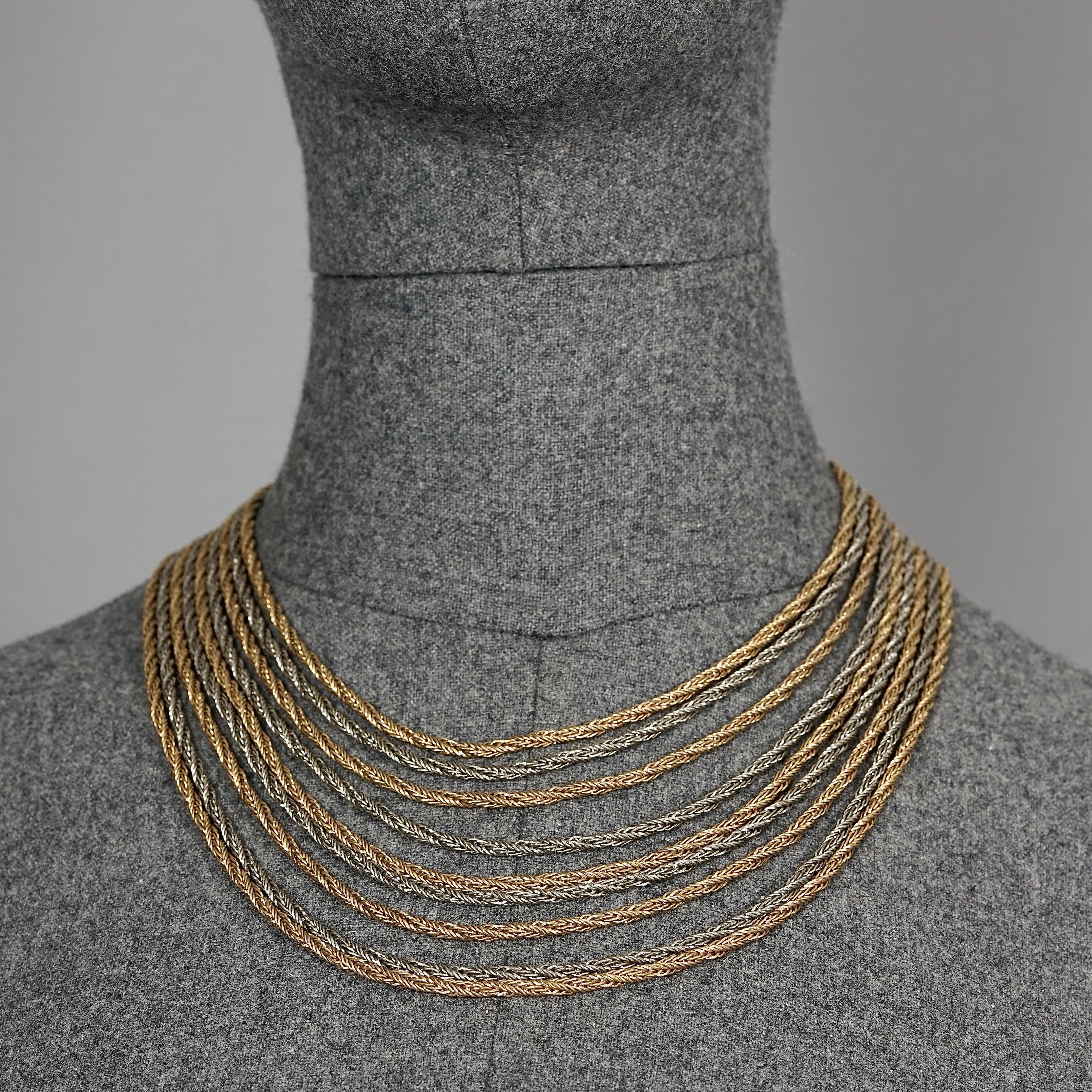 Vintage 1964 CHRISTIAN DIOR 9 Strand Two Tone Chain Necklace

Measurements:
Height: 3.54 inches (9 cm) when worn
Wearable Length: 16.14 inches (41 cm)

Features:
- 100% Authentic CHRISTIAN DIOR.
- 9 strand two tone chain necklace.
- Gold and silver