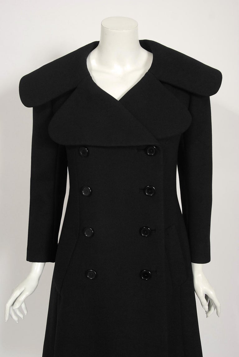 This chic Norman Norell coat, in a timeless black color, exemplifies his signature blend of couture level quality with quintessentially American style. This gorgeous garment, dating back to his 1967-68 fall winter collection, has the most flattering