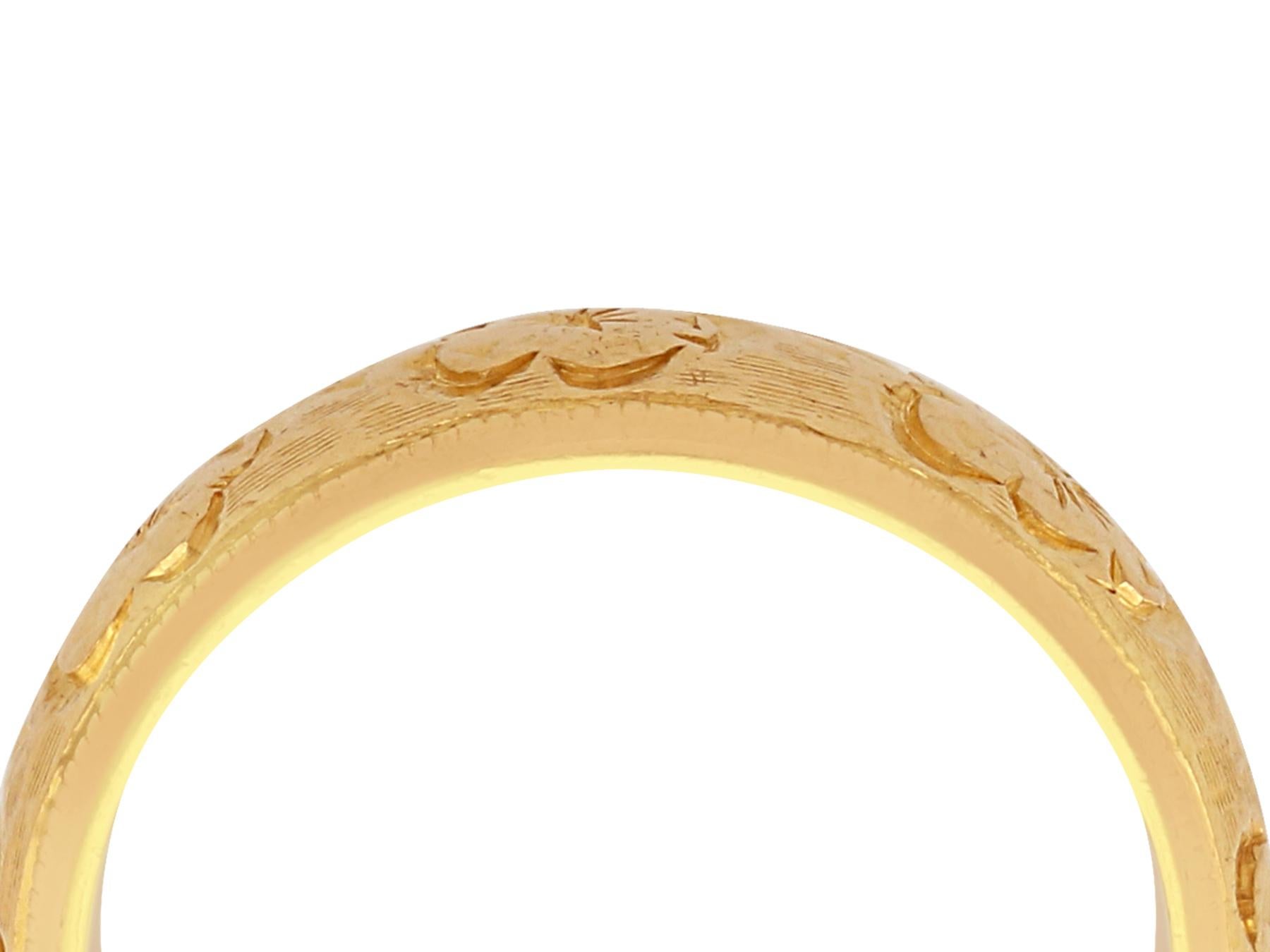 A fine and impressive 22 karat yellow gold, chased decorated wedding band; part of our diverse vintage jewelry and estate jewelry collections

This fine and impressive vintage wedding band has been crated in 22k yellow gold.

The outer surface of
