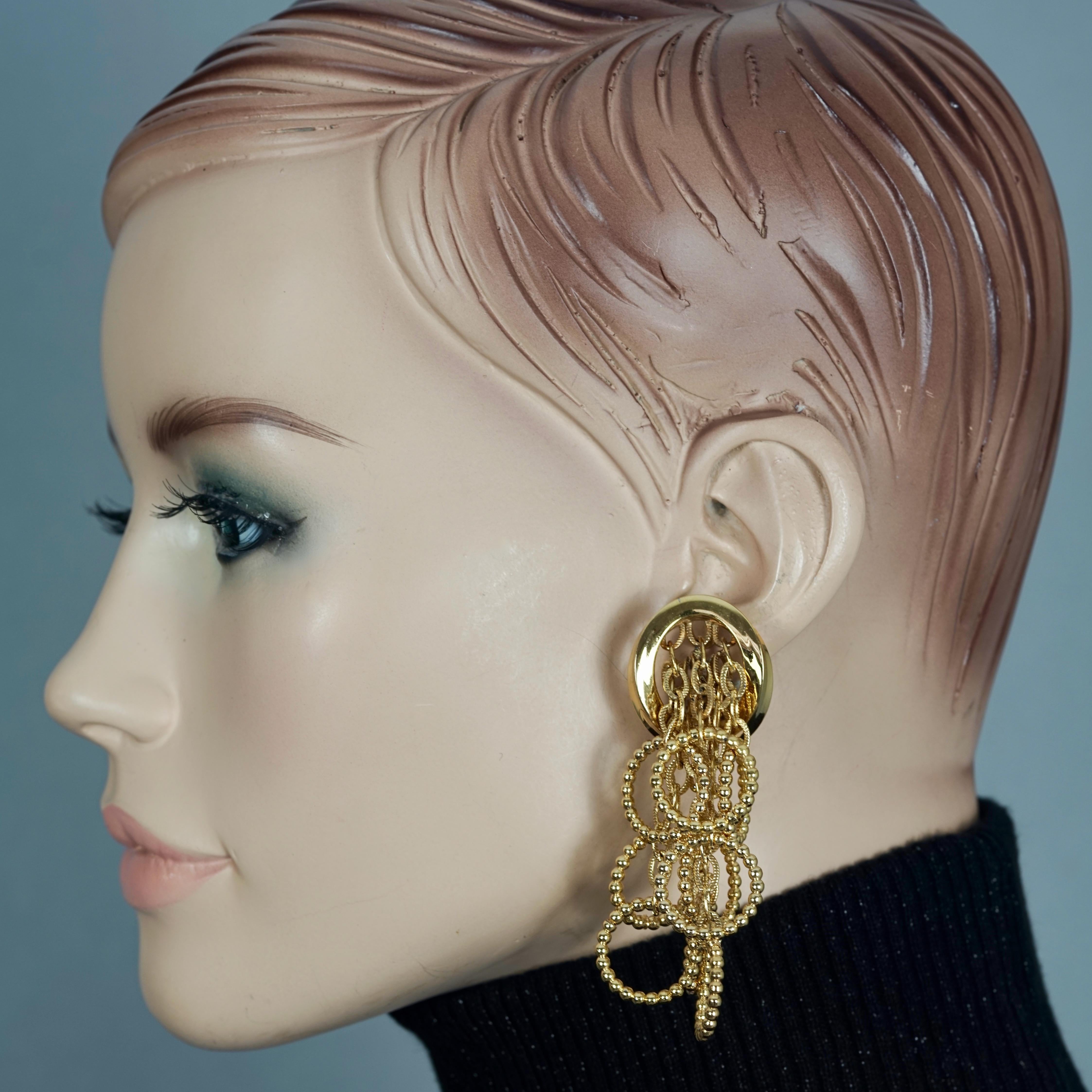 Vintage 1969 CHRISTIAN DIOR Cascading Hoop Dangling Earrings

Measurements:
Height: 2.83 inches (7.2 cm)
Width: 0.98 inch (2.5 cm)
Weight per Earring: 26 grams

Features:
- 100% Authentic CHRISTIAN DIOR
- Cascading twisted hoop charms.
- Gold tone