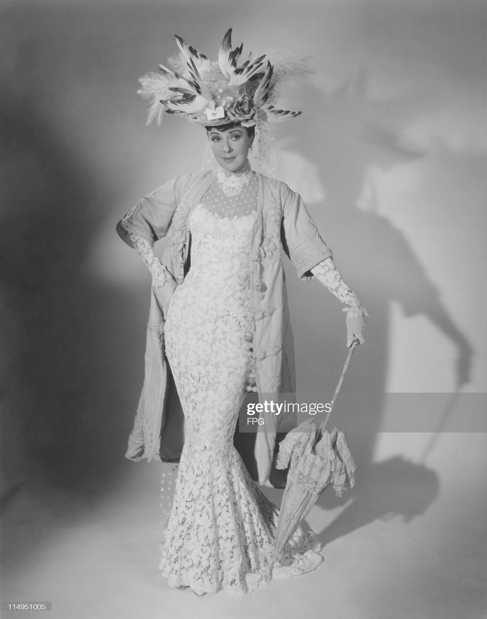 An absolutely gorgeous piece of American film and celebrity history. This breathtaking Victorian ivory lace and pink silk hourglass mermaid gown was custom-made and worn by the iconic Gypsy Rose Lee for her final on-camera performance in 