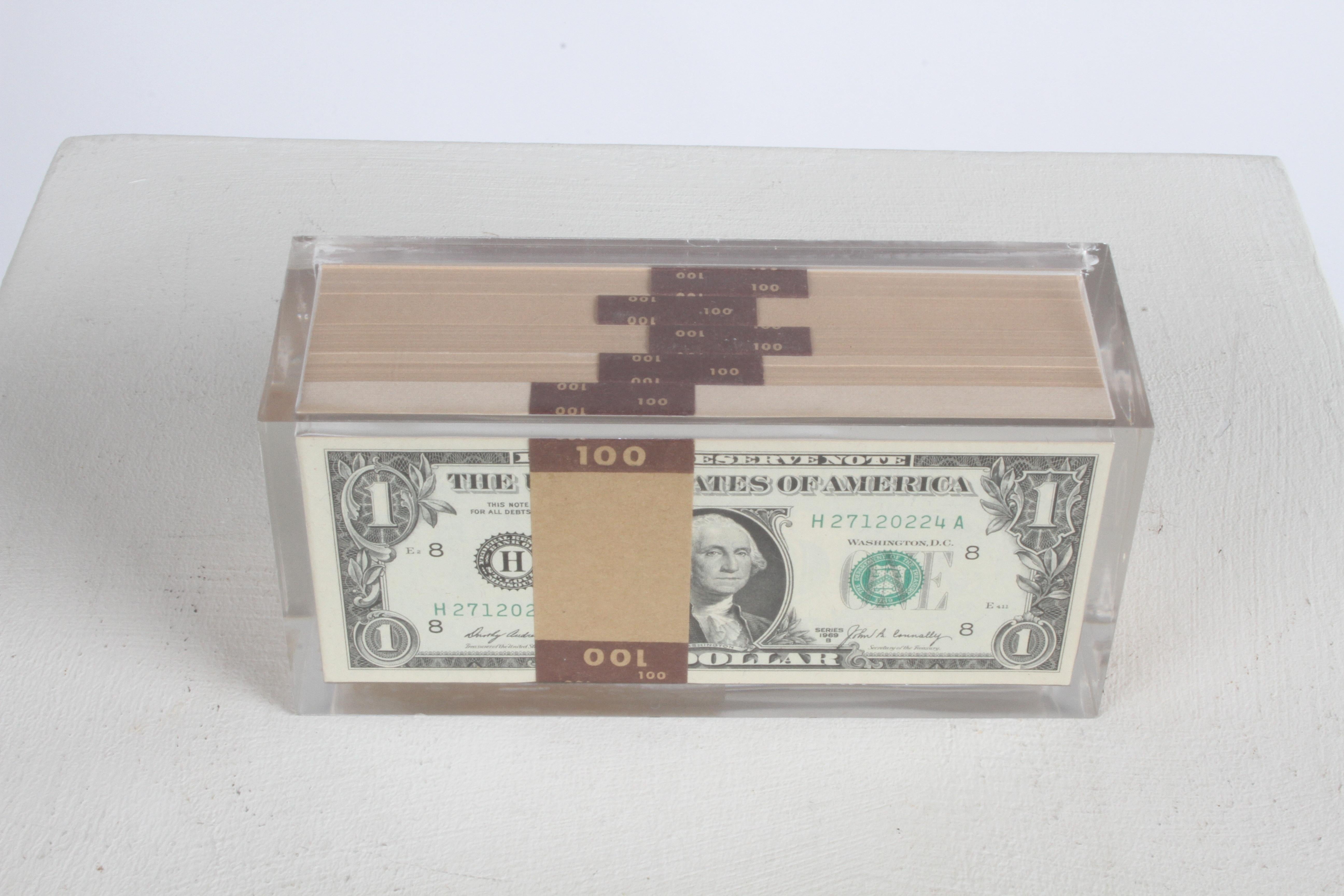 This vintage 1969 pop art illusion Lucite sculpture that has what appears to be a five stacks of $100.00 banded $1 dollar bills inside... It is as if the bank banded these together to with five $100.00 each bands for a total of $500 and then in