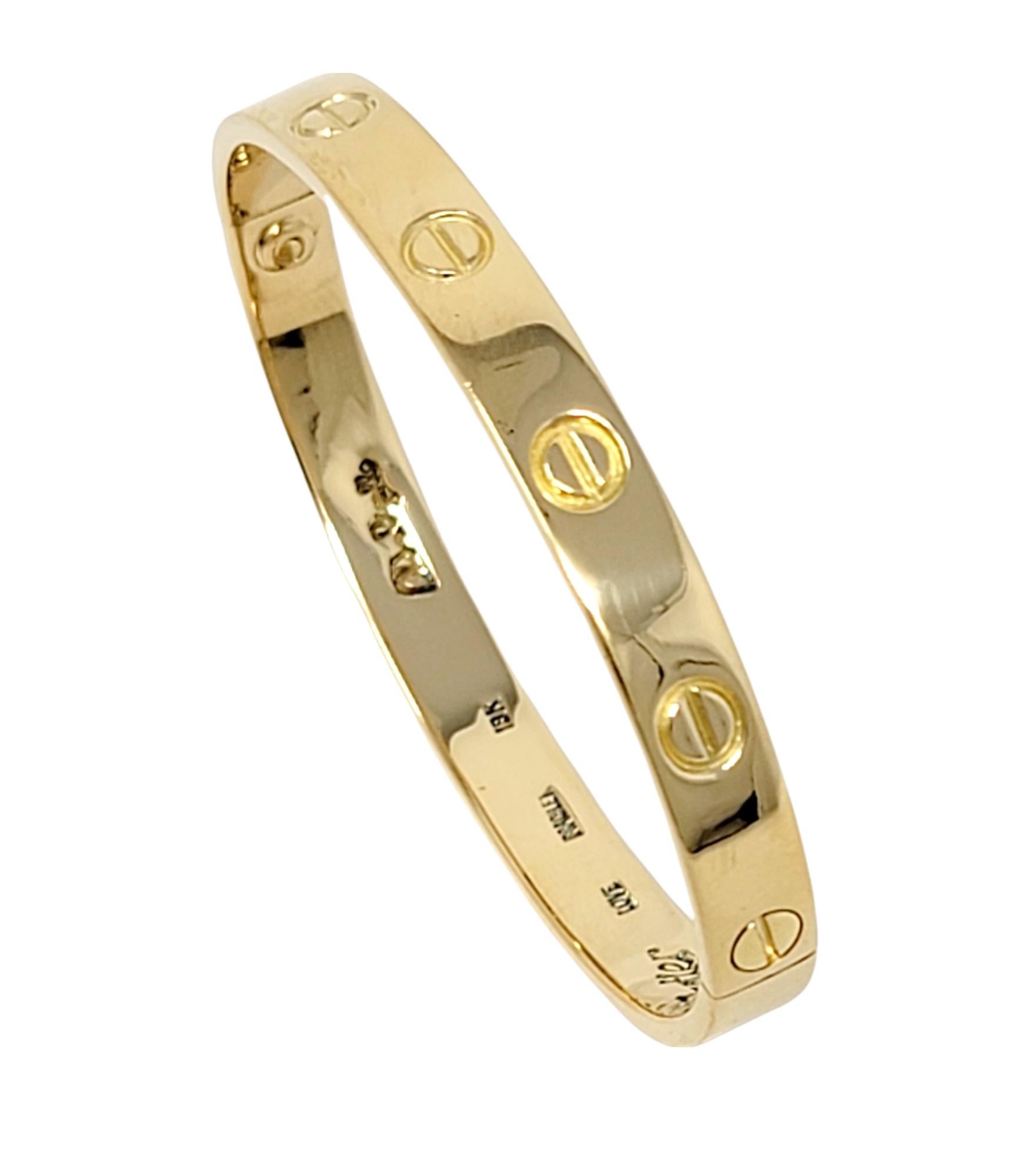 Iconic vintage 1st generation Love bangle bracelet from luxury jeweler, Cartier. This simple, yet effortlessly timeless piece makes a chic statement on the wrist. With its clean lines, perfect symmetry, and flawless elegance, this bracelet will