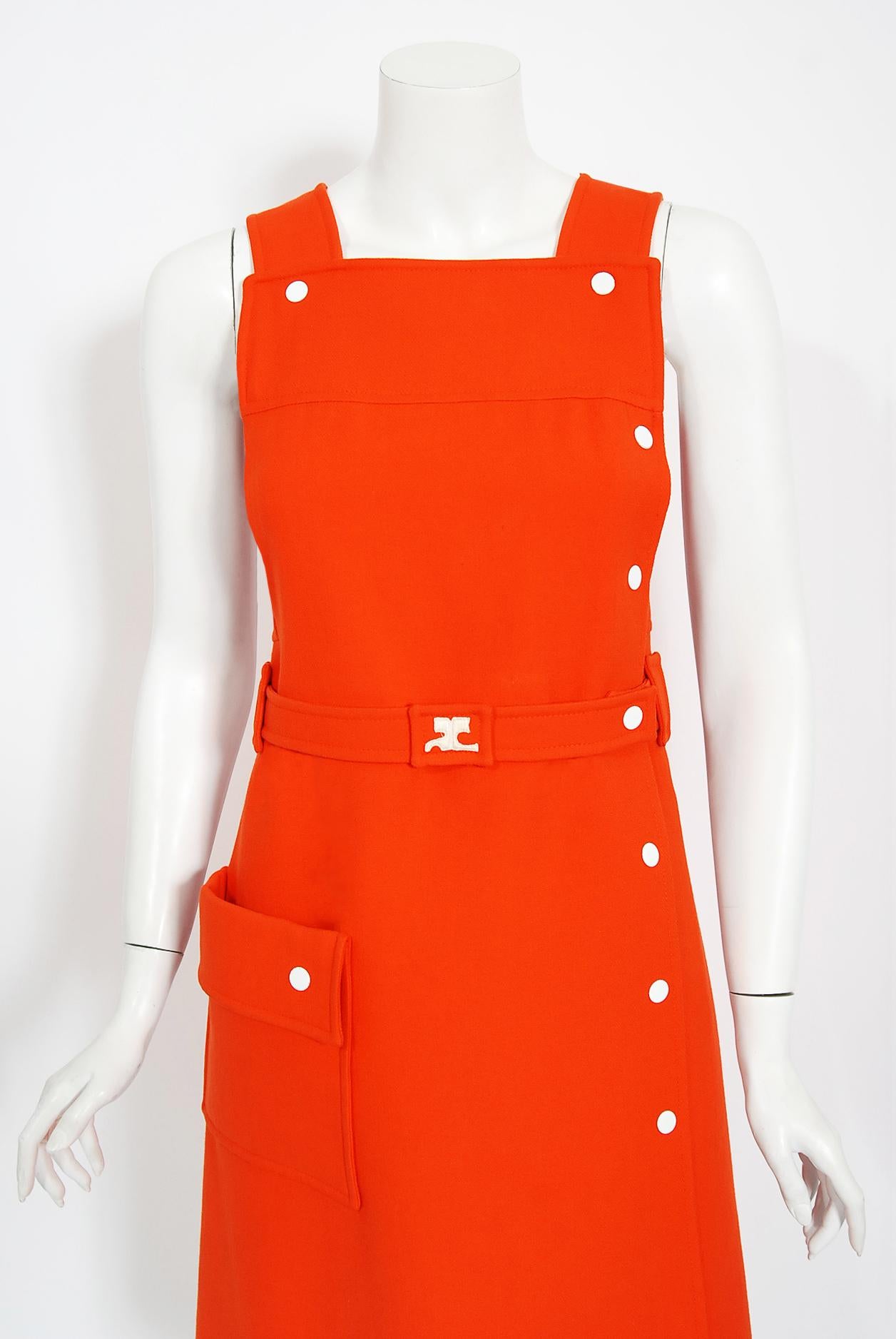 Vibrant and rare-to-find bright orange André Courrèges dress dating back to the early 1970's. Courreges launched his Space-Age collection in 1964. The shapes of his clothes were geometric: squares, trapezoids, triangles. The main features of his