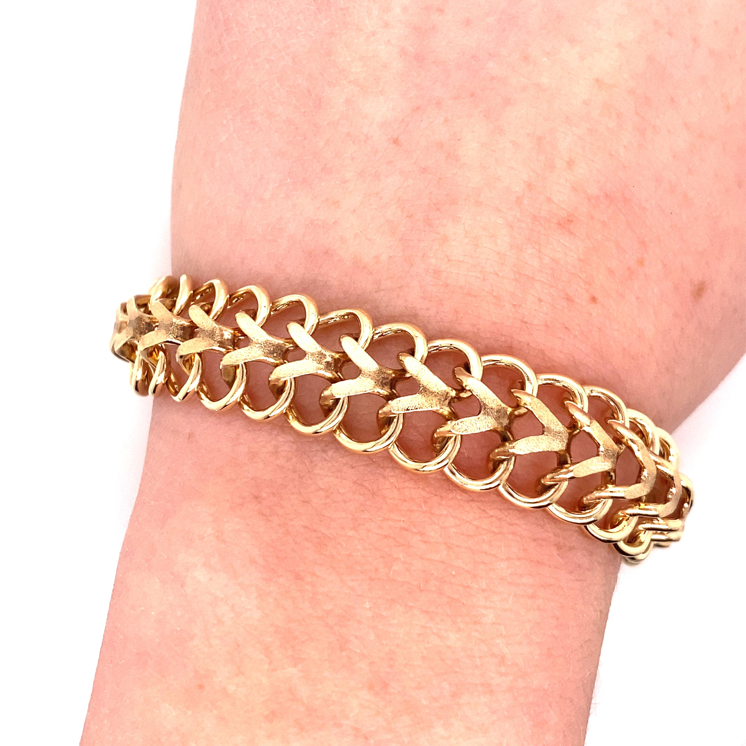 Vintage 1970'S 14K Yellow Gold Charm Link Bracelet - The bracelet measures .5 inches wide and 7.5 inches long and the links are solid. The clasp is a hidden plunger clasp with a safety latch. The bracelet weighs 33.76 grams of gold. 