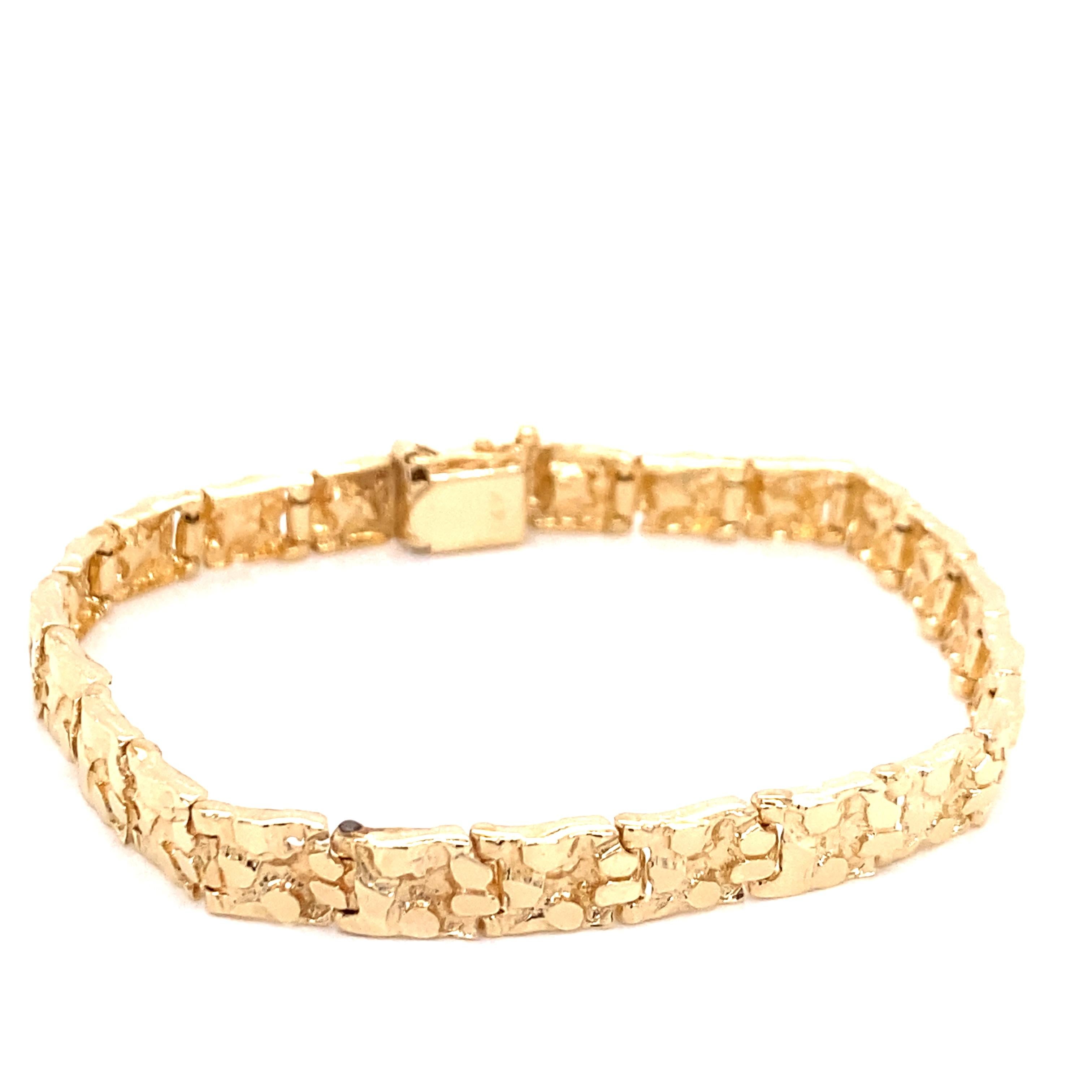 Vintage 1970's 14K Yellow Gold Nugget Bracelet - The bracelet measures .25 inches wide and 7.25 inches long. It has a plunger clasp with a figure 8 safety catch. The bracelet weighs 15.15 grams.