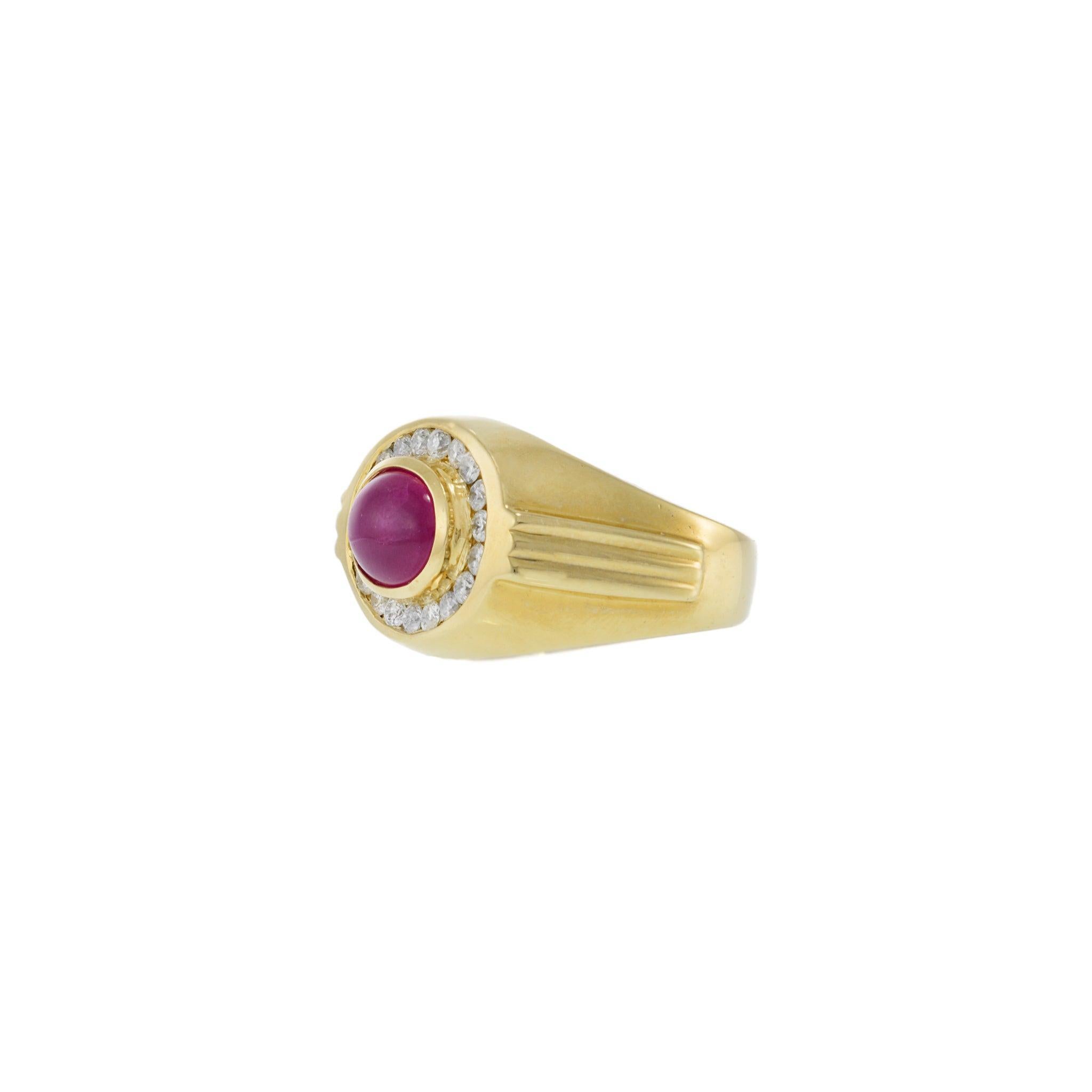 This bold vintage men’s ring from the 1970s is crafted in 14KT yellow gold, featuring a bezel-set oval cabochon ruby weighing approximately 2.30 carats. The ruby is framed by a halo of round brilliant cut diamonds totaling 0.60 carats (H-I color,