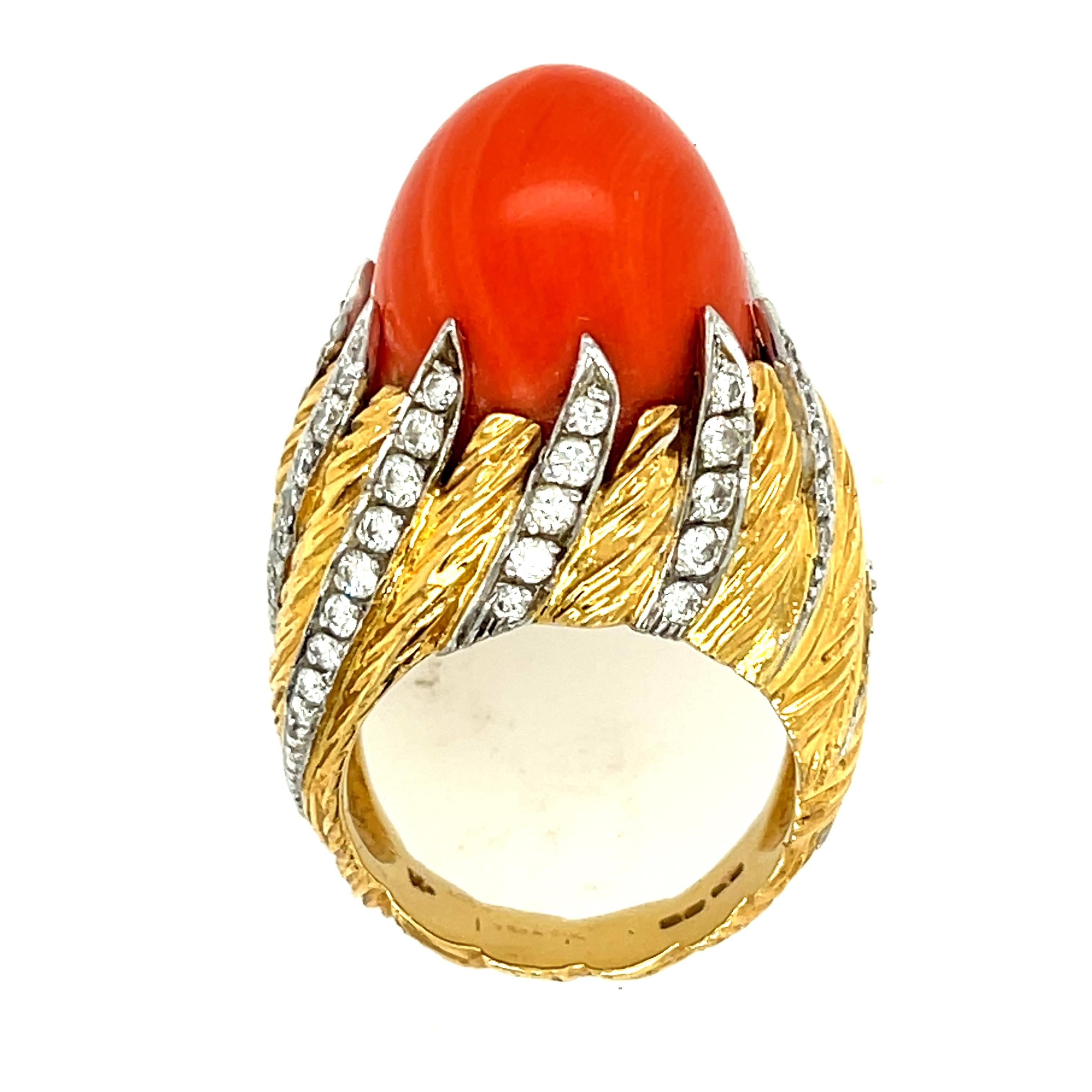 A stunning domed red coral 18K yellow gold ring with diamonds and brushed gold by London jeweler Kutchinsky, circa 1970. Kutchinsky made bold jewels using size and color in 1960s and 1970s. This bombe ring with diamond flames holding in the coral is