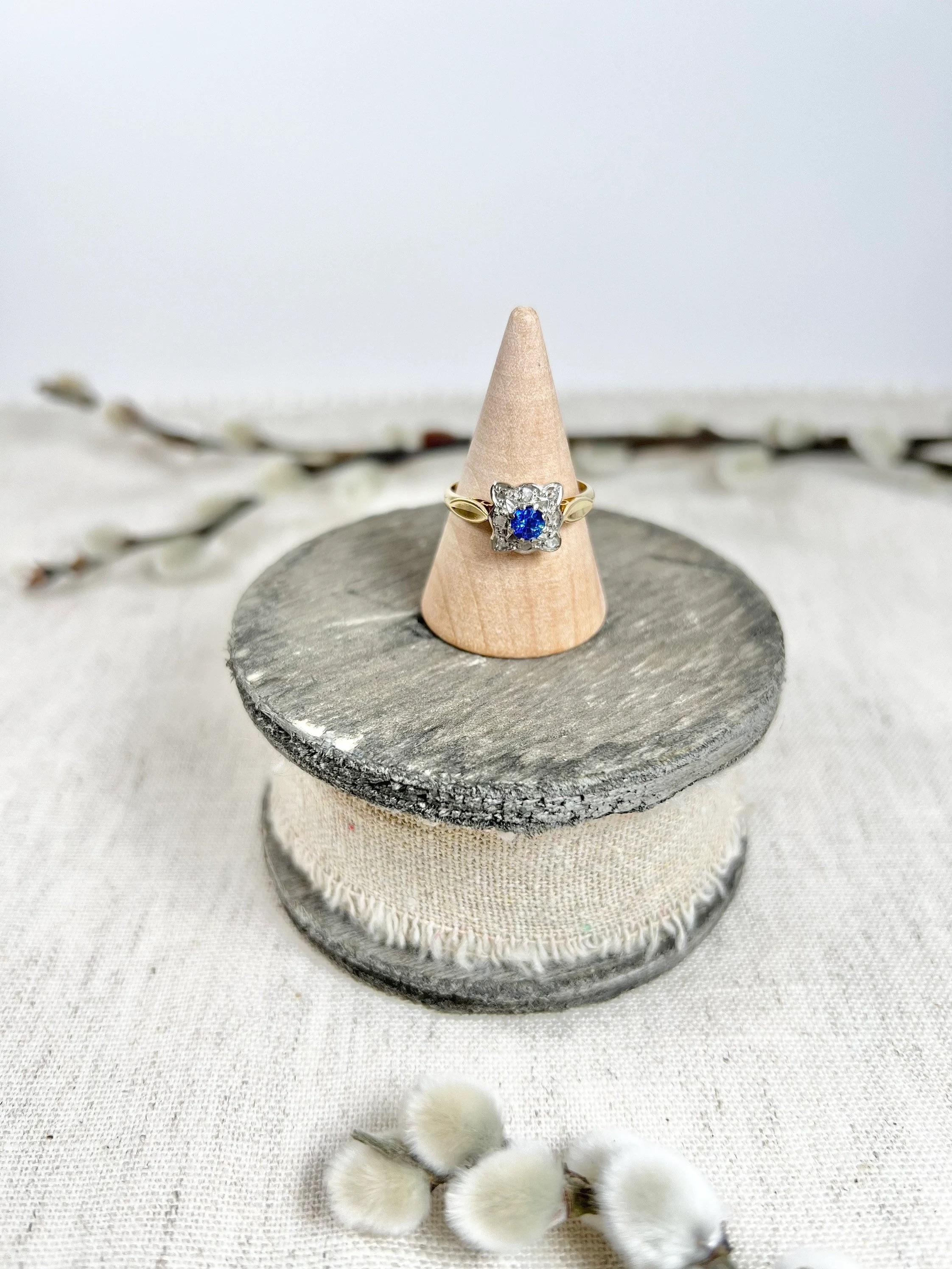 Vintage Sapphire & Diamond Ring 

18ct Gold Stamped 

Hallmarked London 1971

Makers Mark B K T 

Beautiful, square shaped, vintage cluster ring. 
Set with a centre, natural sapphire & surrounded by a cluster of beautiful, eight cut, natural