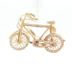 Vintage 1970s 18K Gold, Diamond, and Ruby Bicycle Brooch with Articulated Wheels