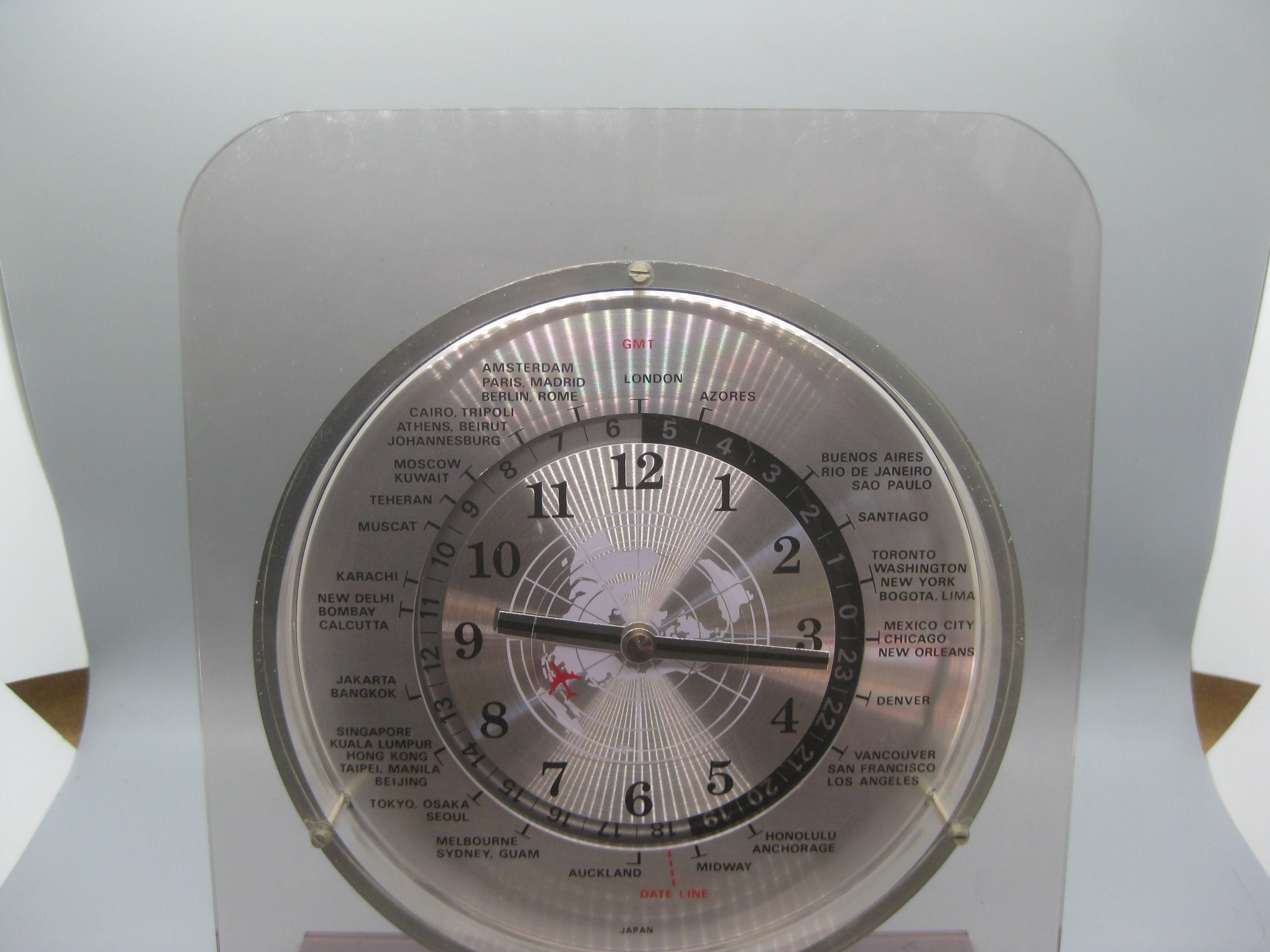 Wonderful smoked lucite/acrylic world desk/table clock that dates from the 1970's to 1980's. Made by GMT and works great. The clock is battery operated. In very nice original condition. No chips, no cracks and no repairs. There are some light