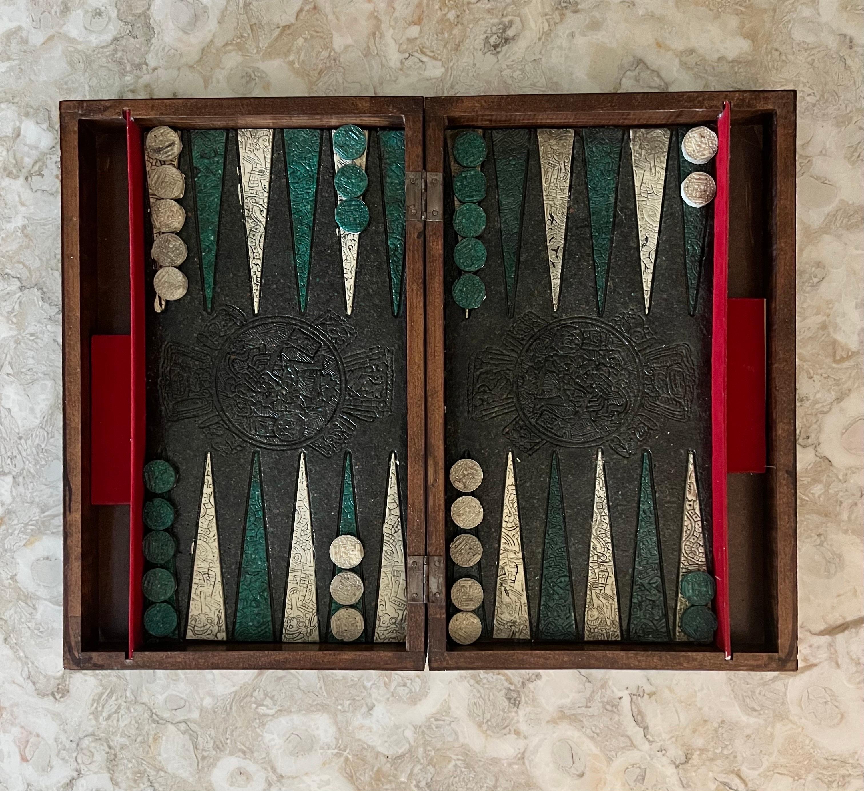 Vintage 1970's backgammon and chess set depicting the Spanish conquest of the Aztec Empire, 1519-21..   

Carved chessman portray the great Montezuma II and Aztec warriors defending their land against Cortés and his men.  The faux stone playing