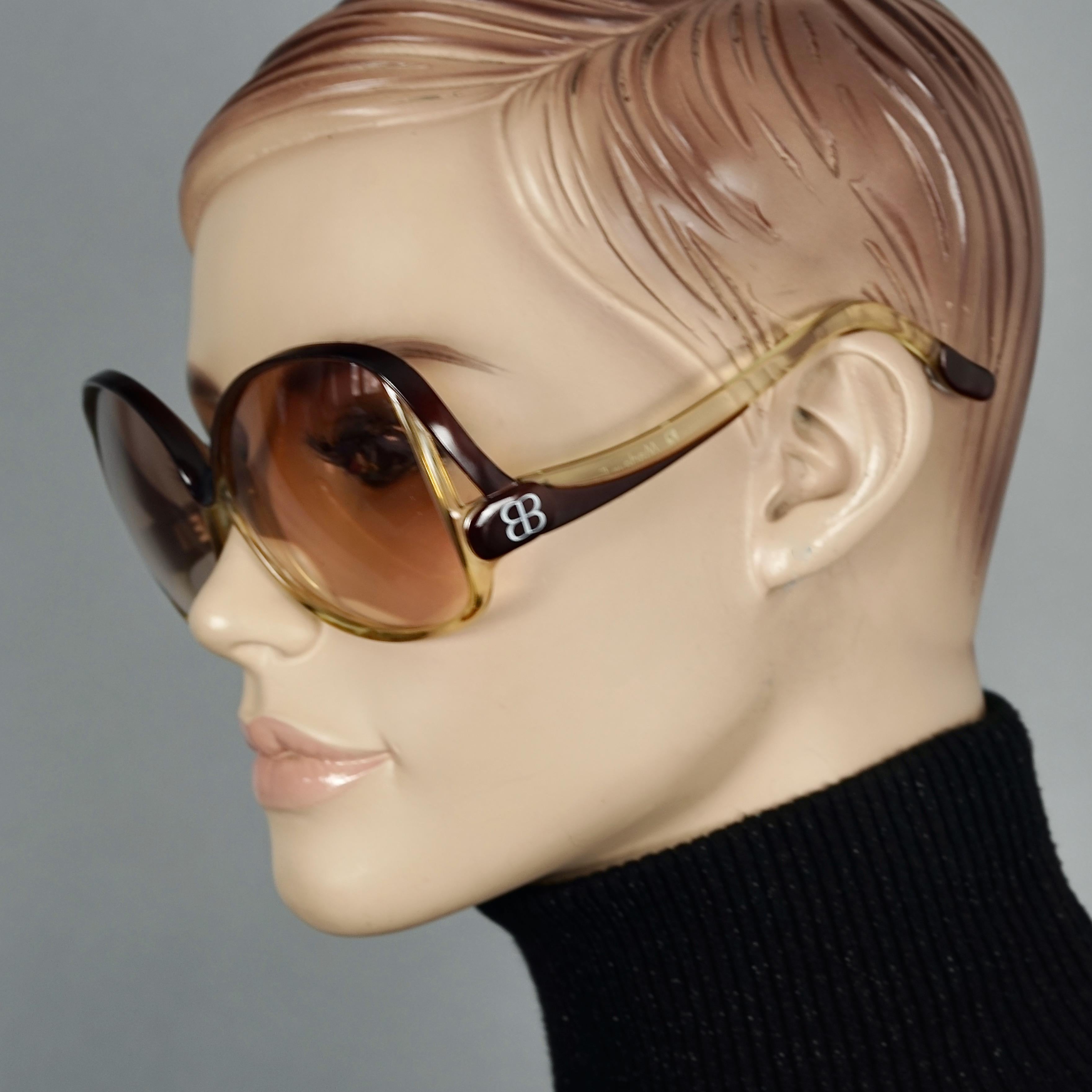 Vintage 1970s BALENCIAGA Oversized Two Tone Sunglasses

Measurements:
Lens Height: 2.48 inches (6.3 cm)
Horizontal Width: 5.55 inches (14.1 cm)
Arms: 4.72 inches (12 cm)

Features:
- 100% Authentic BALENCIAGA. 
- Two tone oversized sunglasses.
- BB