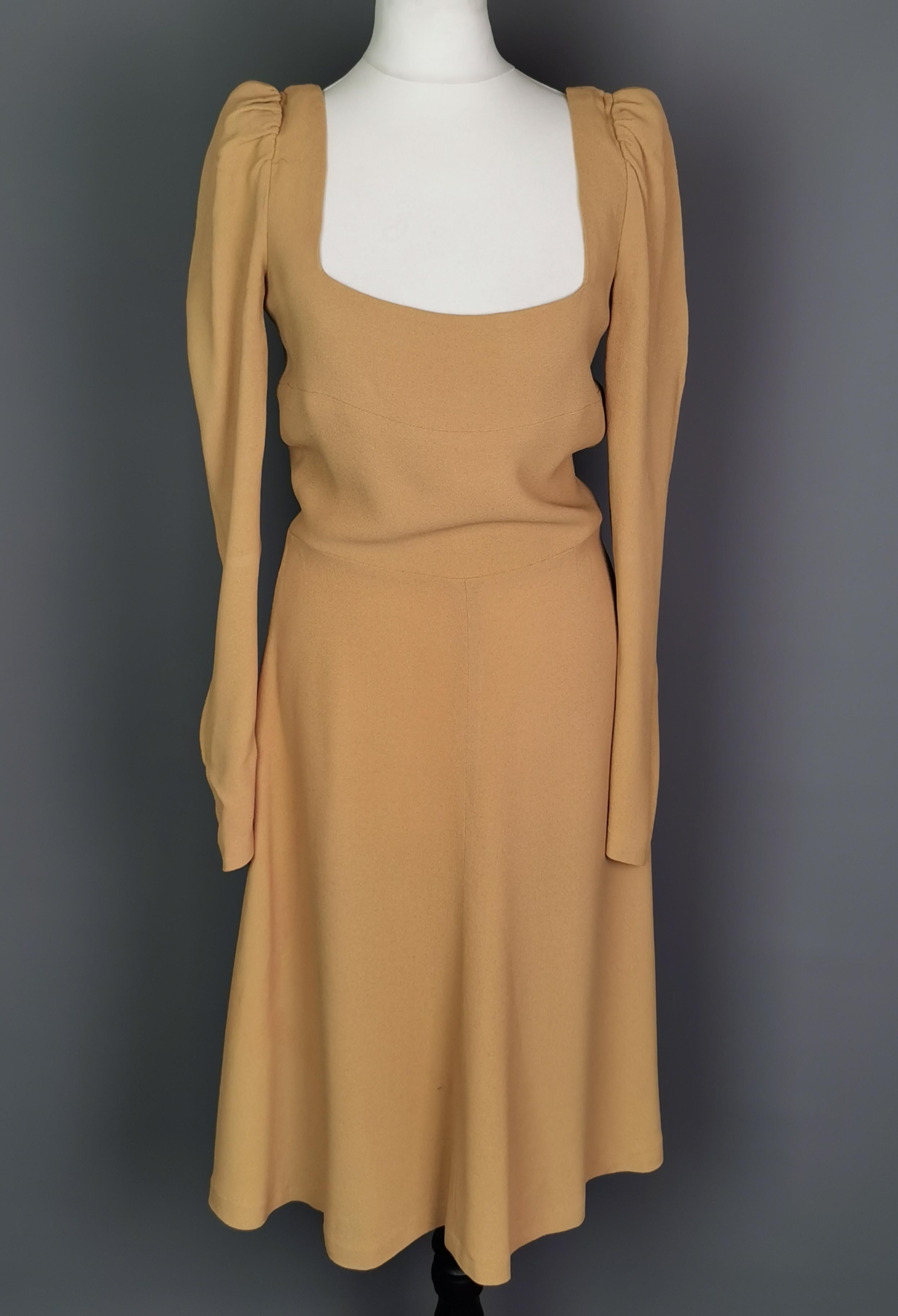 A gorgeous, stunning, rare vintage Biba original 1970s mini dress.

This dress was created at the height of Bibas popularity and the time they produced some of their most iconic designs.

This deep mustard crepe mini dress has long tapered sleeves,