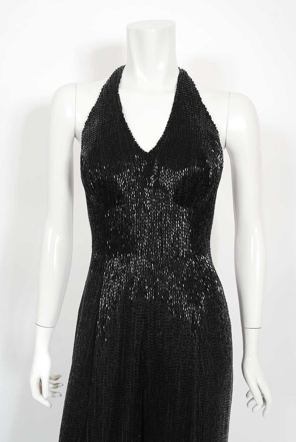 An ultra chic and incredibly timeless custom couture black fully-beaded jumpsuit dating back to the late 1970's. This captivating showstopper was designed by the famous 'J & M Costumers' in Hollywood; who still do specialized work for the