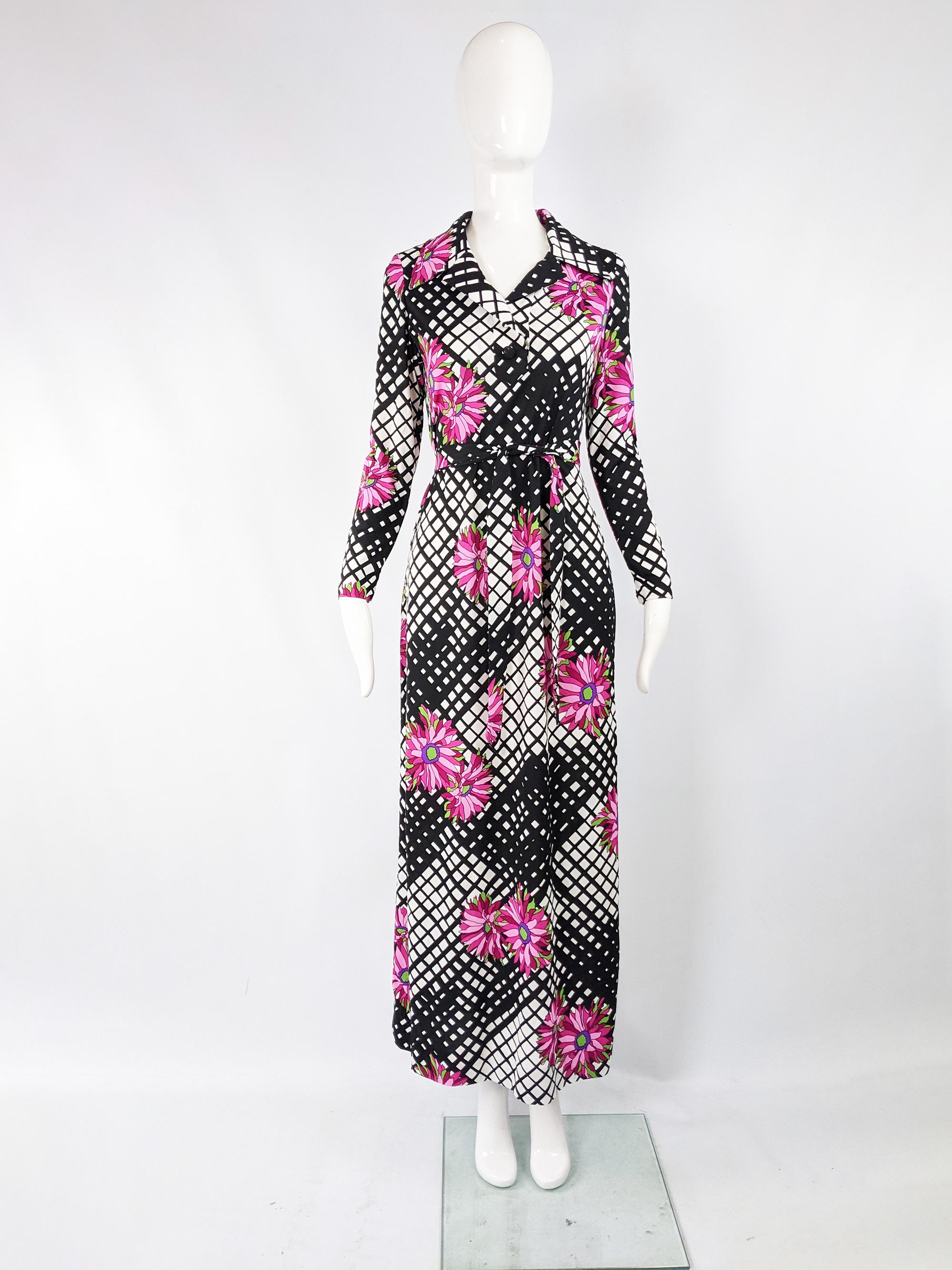 A beautiful vintage maxi dress from the 70s in a black and white synthetic jersey with a bold pink floral print. It has long sleeves and a wide collar. 

Size: Unlabelled; fits like a UK 12/ US 8/ EU 40. Please check measurements. 
Bust - 36” /
