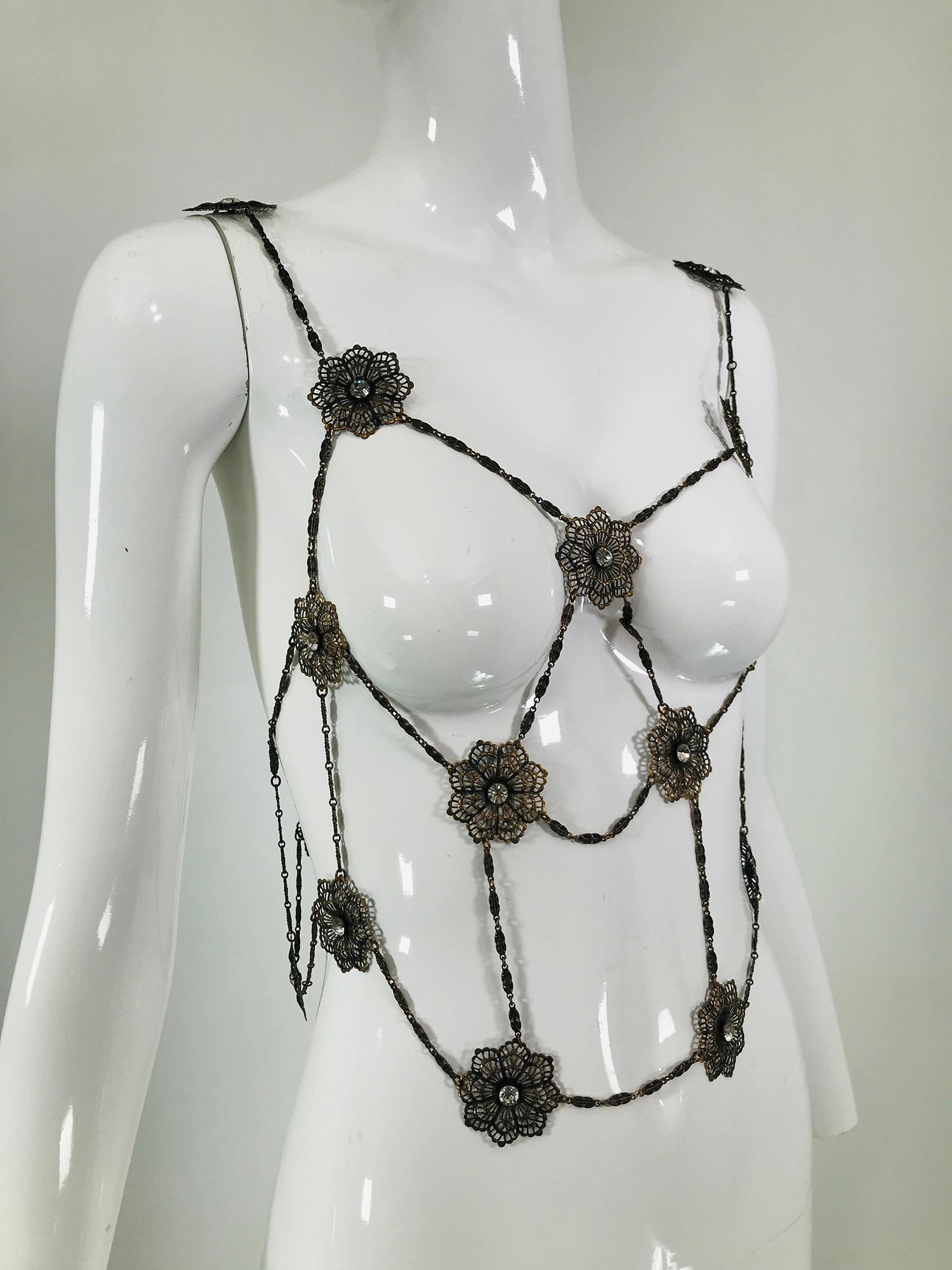 Vintage body jewelry, filigree brass & rhinestone bolero from the 1970s.  Decorative chain with round filigree brass circles that are prong set with crystal rhinestones at the center. The bolero top is the perfect thing to wear over a plain black
