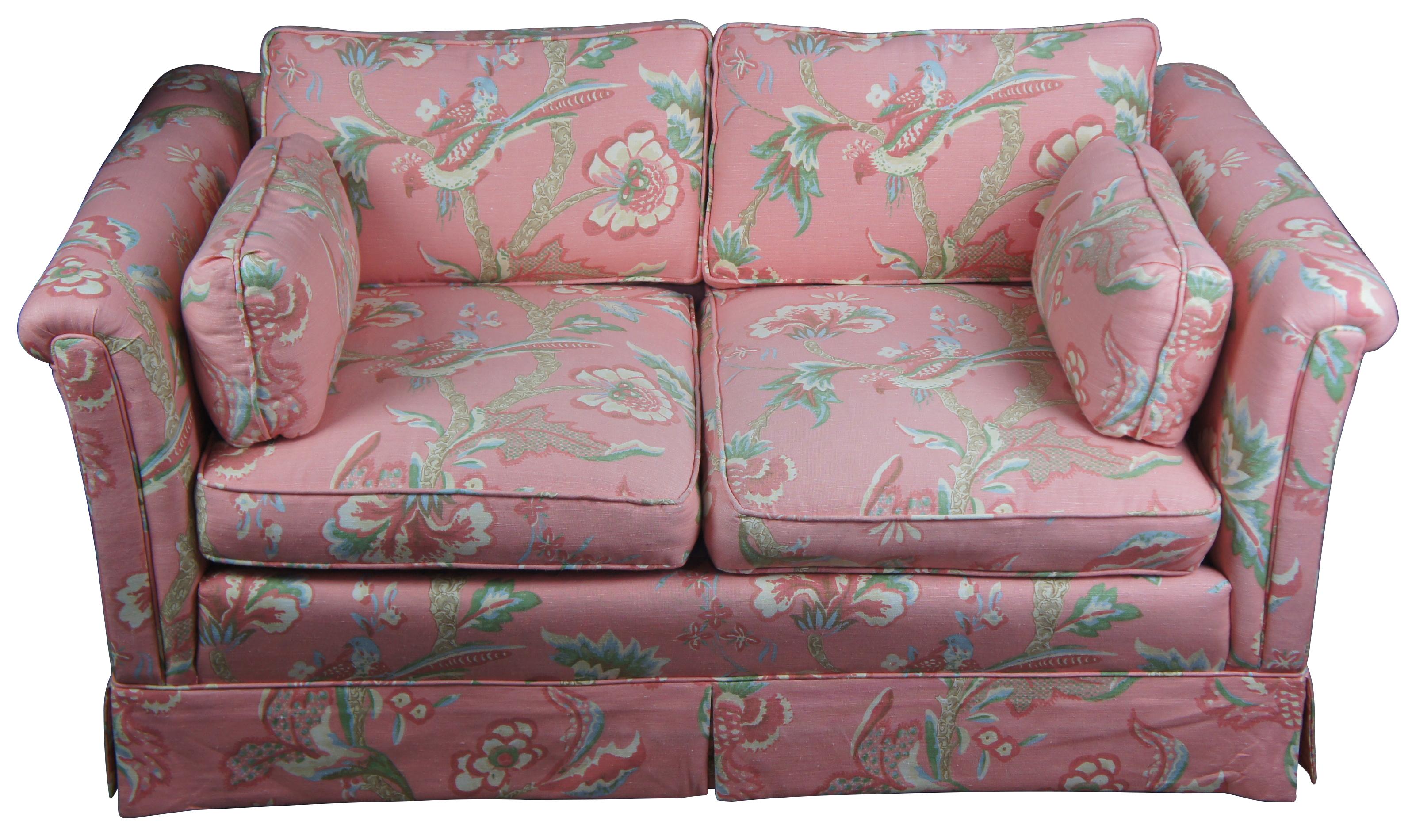 Quant loveseat or sofa, circa 1970s. Features a pink tropical bird fabric with bolster pillows and arm covers. Measures: 60”.
 