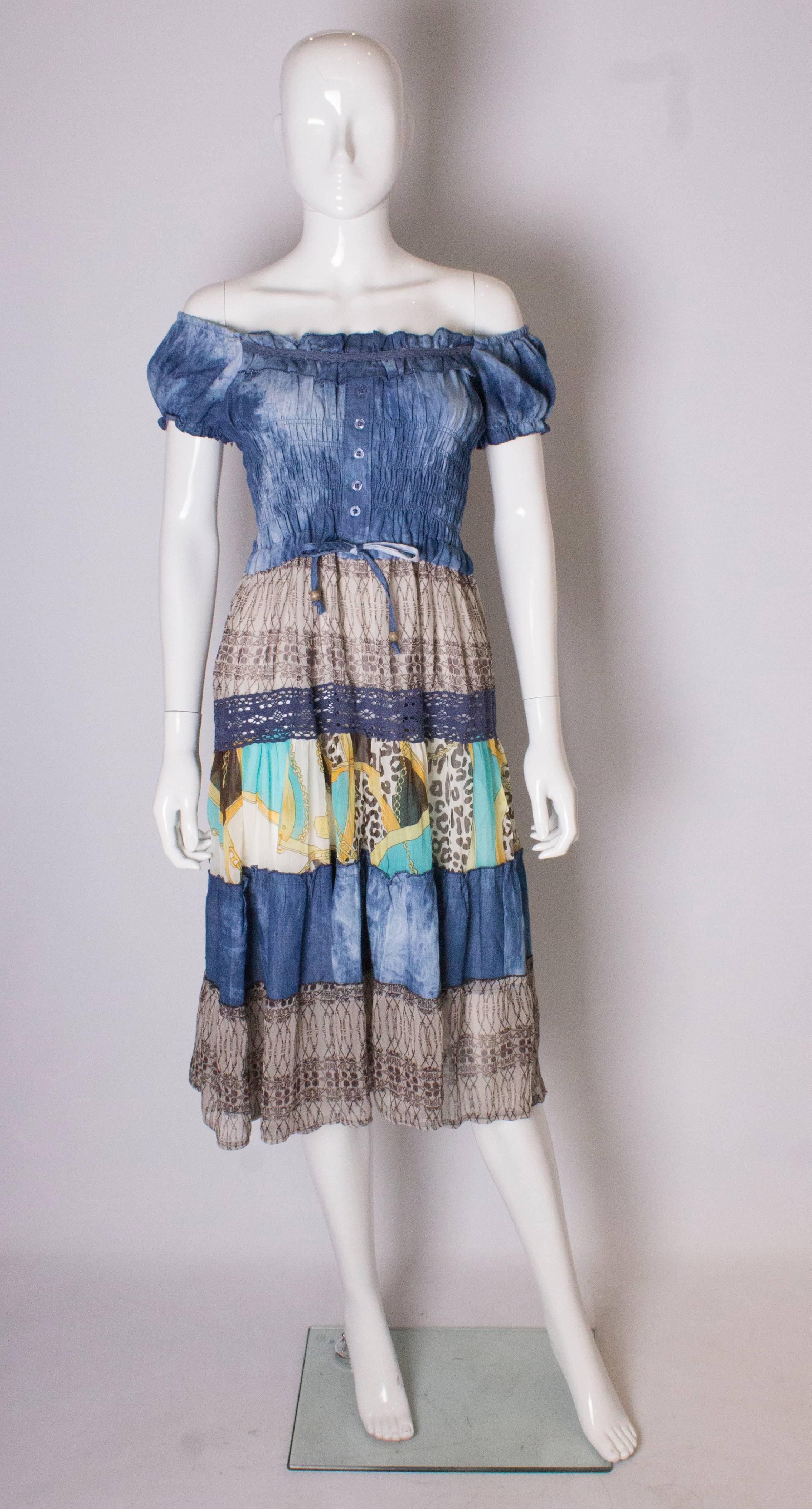 1970s  boho  summer dress, it has a blue top half with elasticated off the shoulder neck /shoulder line. The skirt has tiers of silk, and the dress is fully lined.