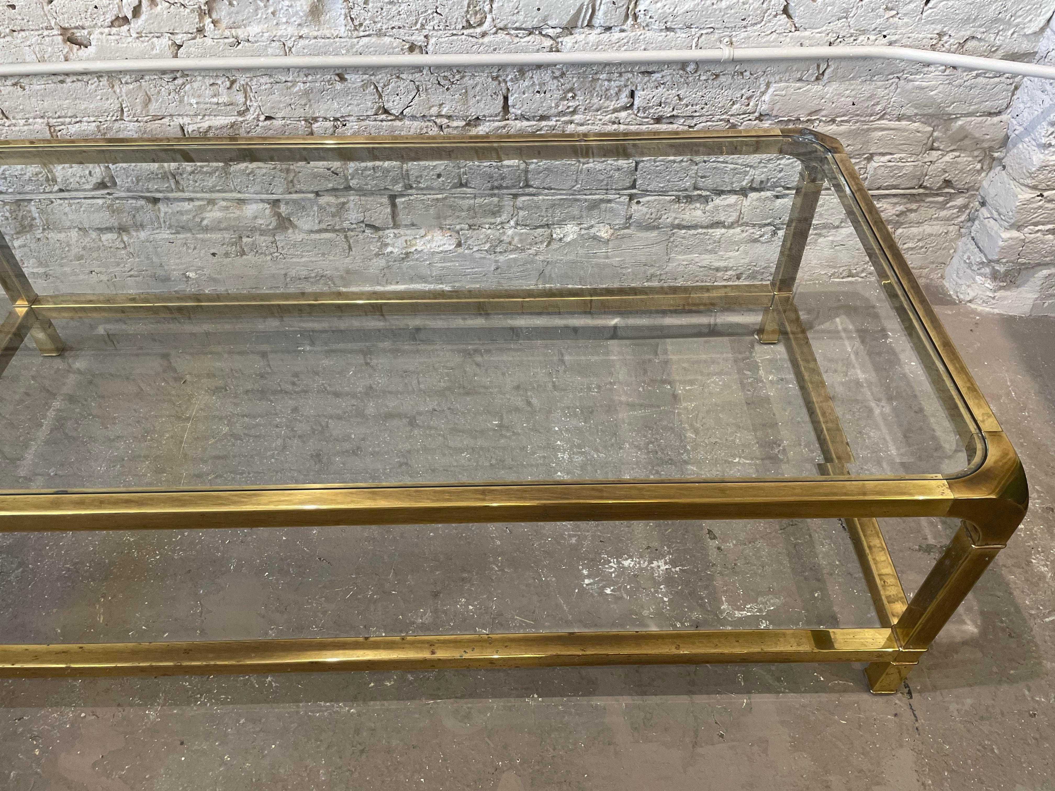 Beautiful brass coffee by Mastercraft. I love this table! I personally own 2 of them:)

One corner has a bit of patina. Please look at pictures. I always love the character this brings. 

DIMENSIONS: 55ʺW × 28ʺD × 17ʺH  
STYLES: Hollywood Regency,