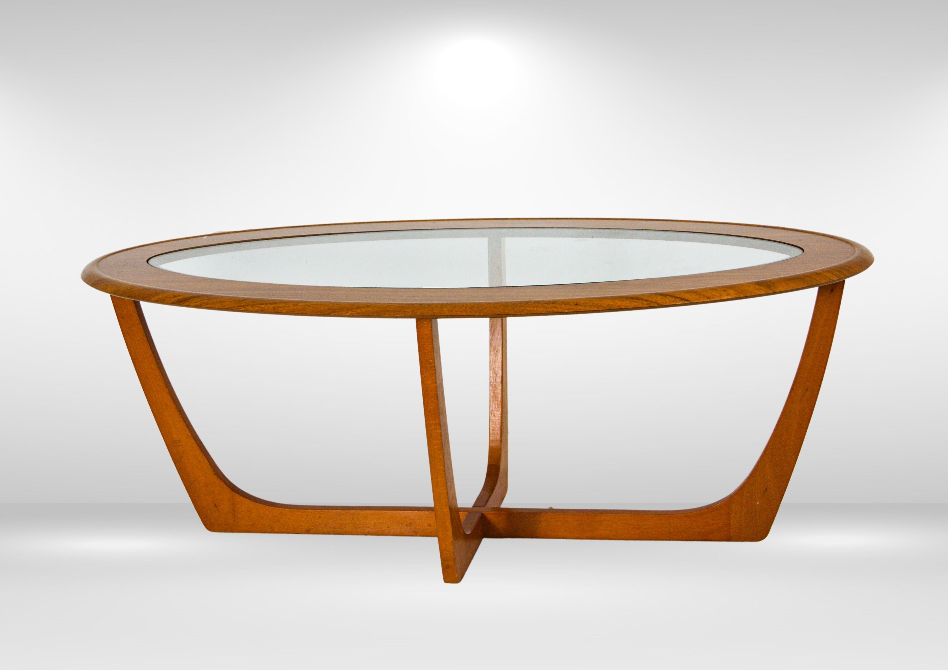 Vintage 1970s oval shaped glass and teak coffee table.
British design in the style of a G Plan 'Astro coffee table'.
Solid teak base, with a teak veneer to the top.
The slim oval glass top sits inset on the solid teak base.

In very good