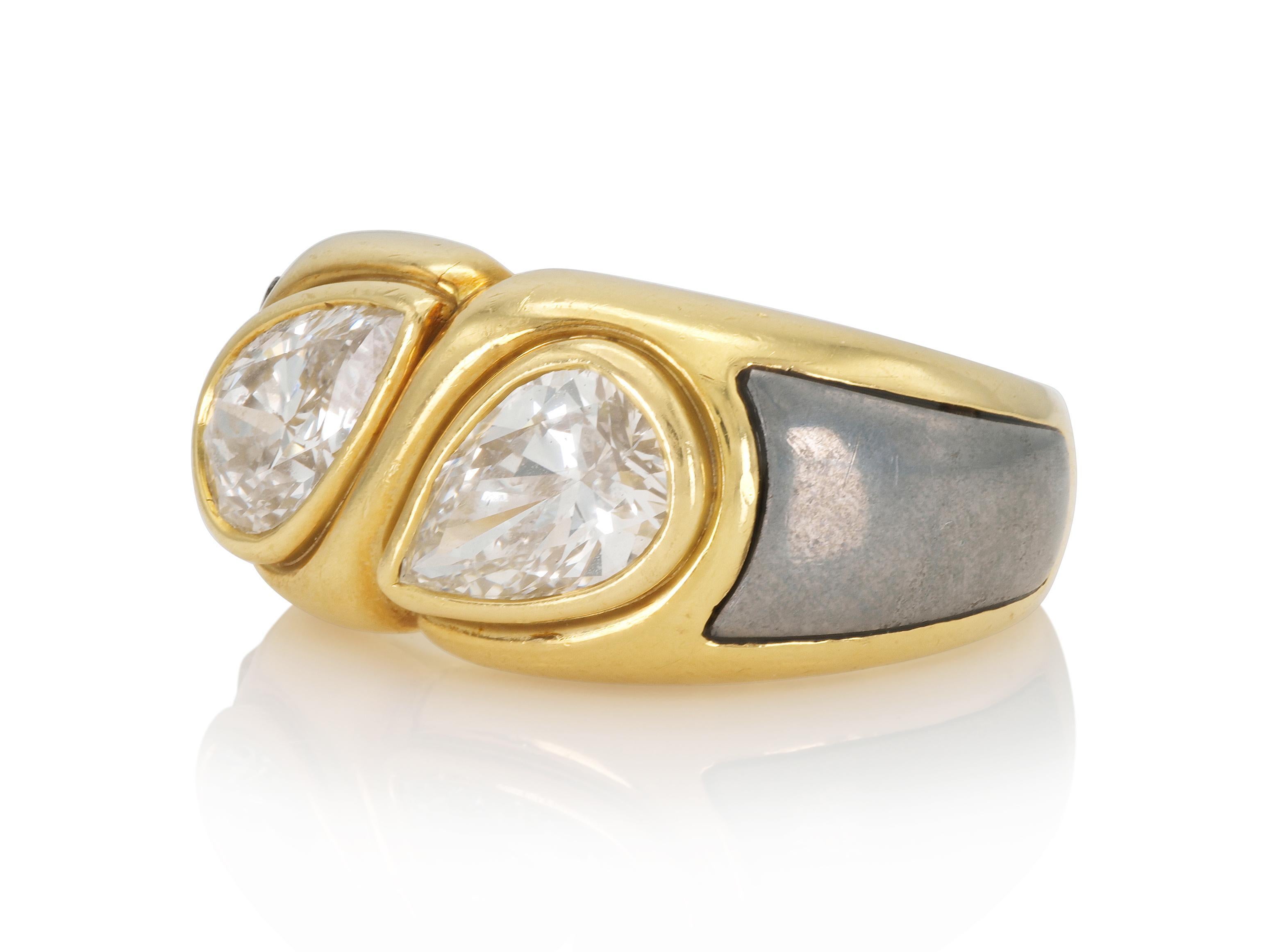 Finely crafted in 18k white and yellow gold with two Pear-Shaped Diamonds; one weighing 1.17 carat, the other 1.16 carat, G color, VS clarity.
Signed by Bvlgari
Circa 1970s
Size 7 1/4, resizable