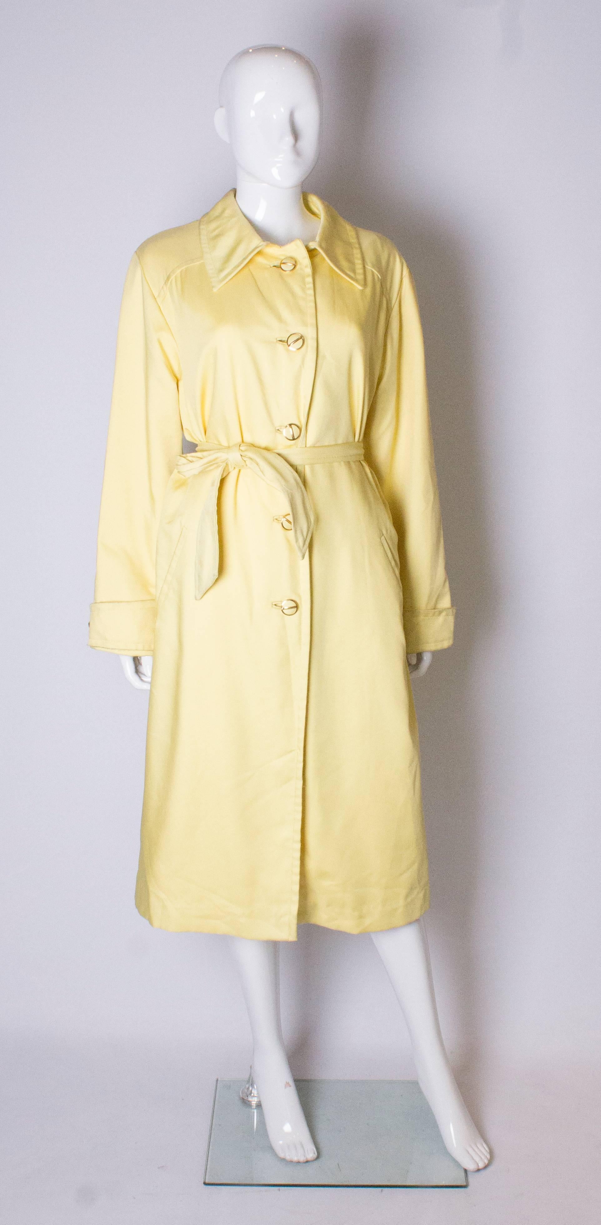 A great vintage  coat for Spring. The coat has a fabric covered buttons and a self fabric belt.