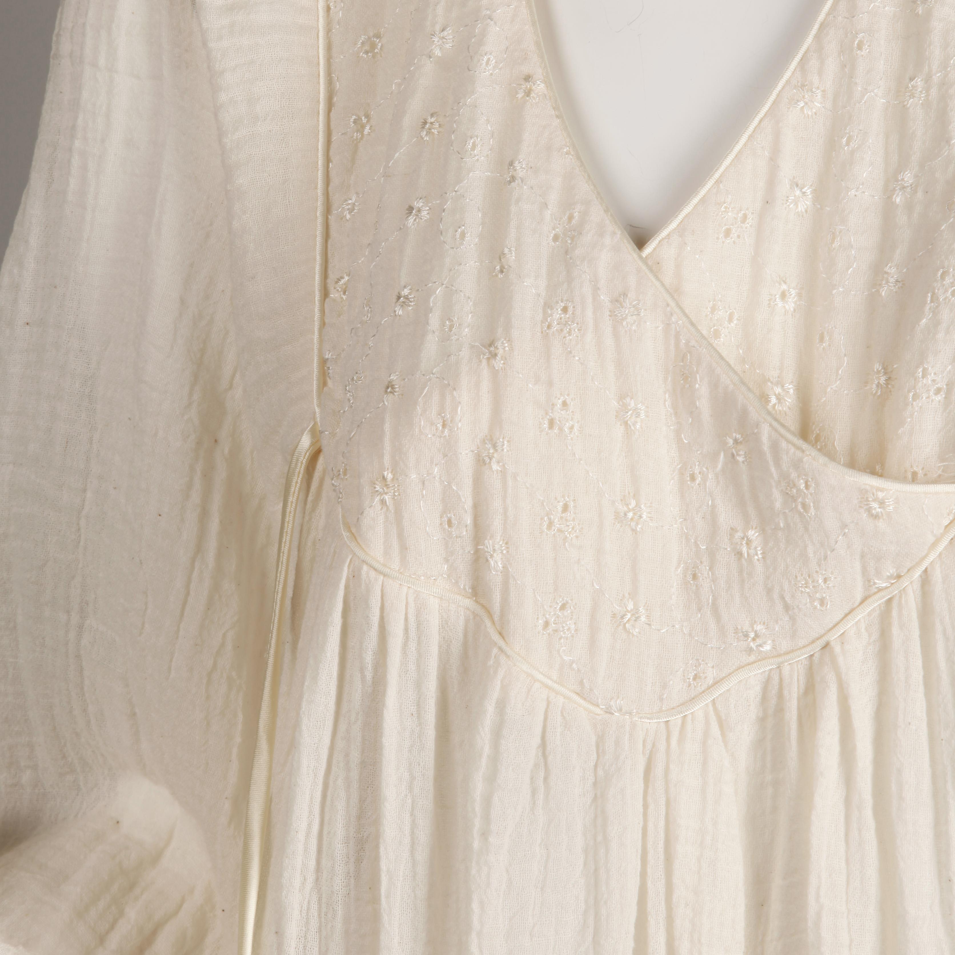 Beautifully done vintage 1970s off white cotton gauze peasant style dress with full blouson sleeves and eyelet fabric detail at the bust. This fabric is very light weight and almost sheer. Empire waist. Unlined with no closure (pulls on over the