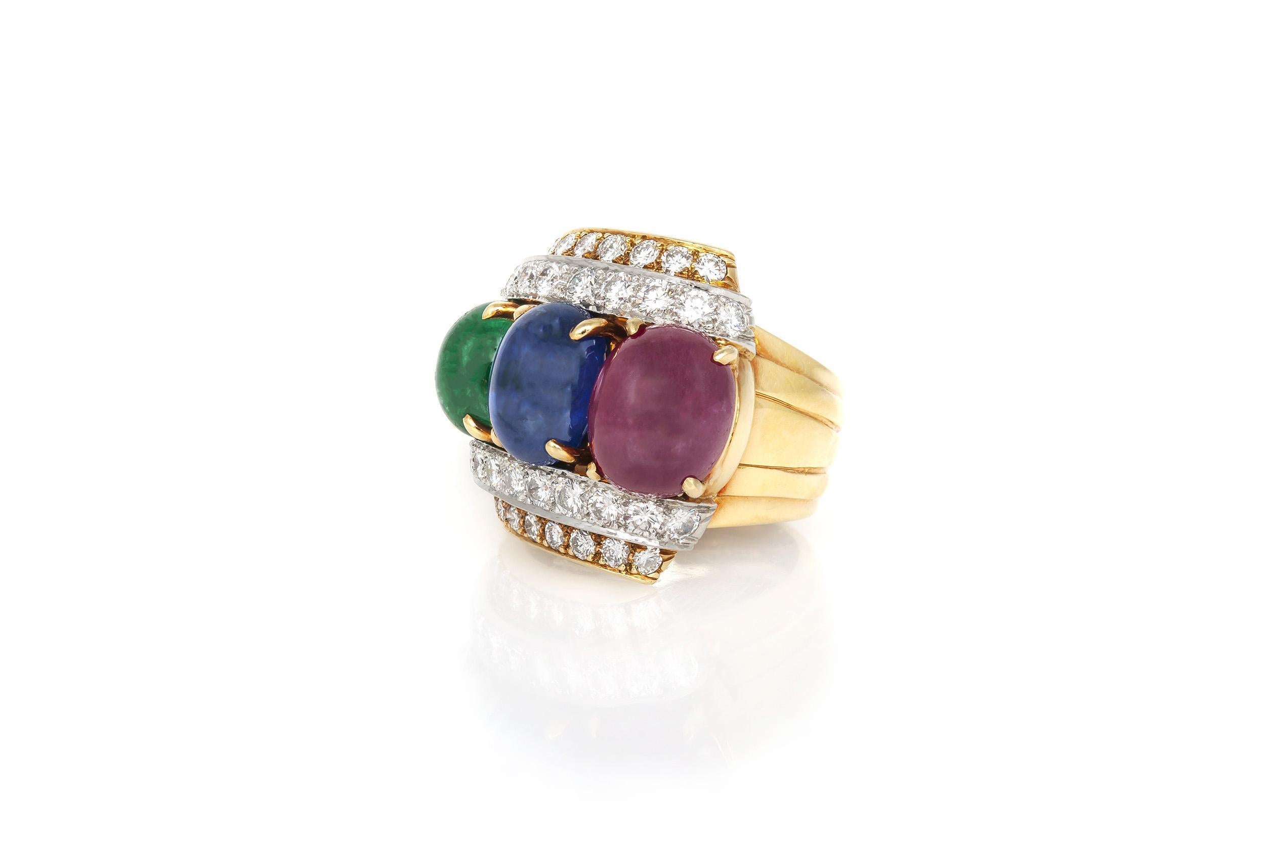 Fein gearbeitet in 18 Karat Gelbgold und Platin mit einem Cabochon-Rubin von 5,71 Karat, einem Cabochon-Saphir von 4,94 Karat und einem Cabochon-Smaragd von 2,25 Karat. Der Ring enthält runde Diamanten im Brillantschliff mit einem Gesamtgewicht von