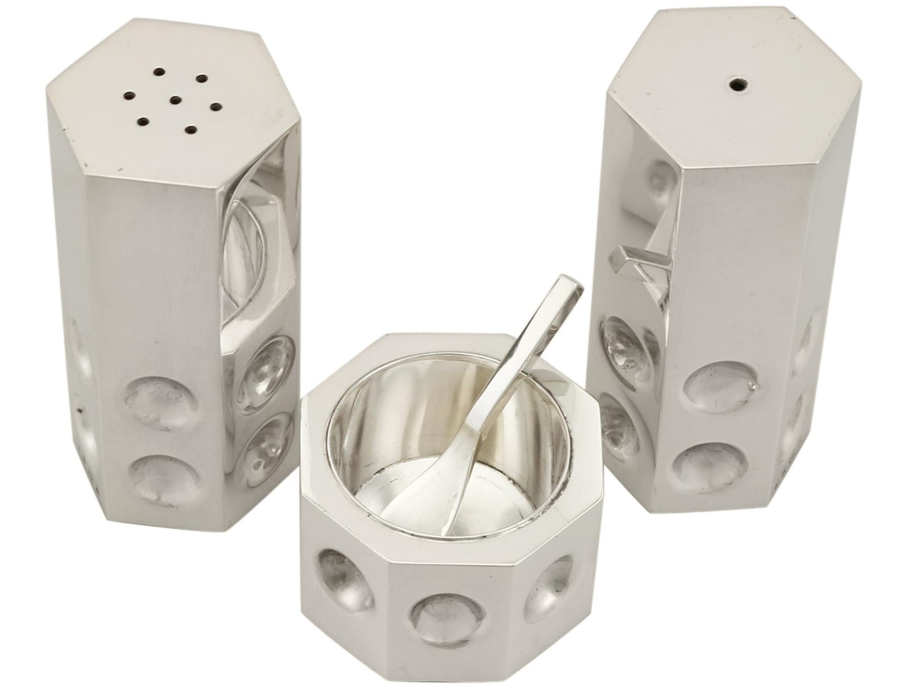An exceptional, fine and impressive vintage Elizabeth II English sterling silver three-piece condiment set made in the design style; part of our 1970 silver dining silverware

This impressive vintage sterling silver three-piece condiment set