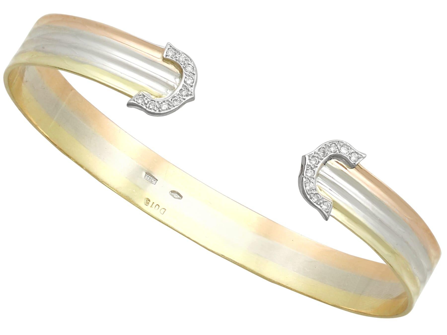 An impressive vintage Italian 0.86 carat diamond and 18 karat white, yellow and rose gold jewelry set of bangle, ring and earrings; part of our diverse diamond jewelry collections.

This fine and impressive vintage gold jewelry set has been crafted