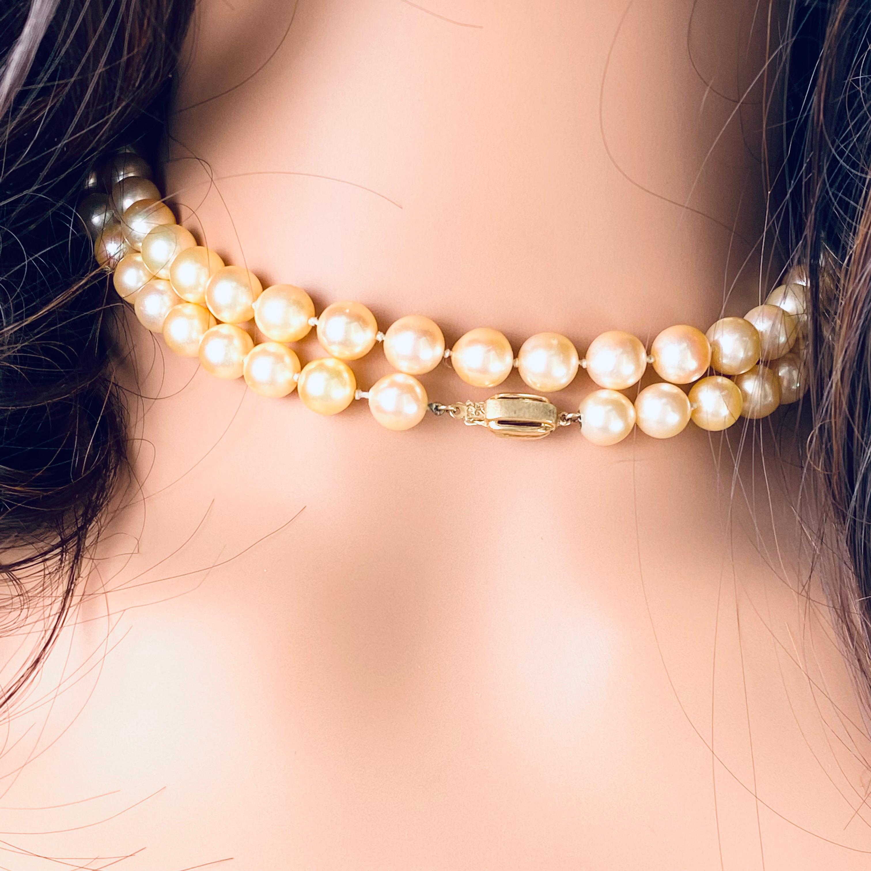 Vintage 1970s Double Strand Cultured Pearl Necklace - Creamy Beige Golden Hue, 30-Inch Length, 14K Yellow Gold Clasp
Description:
Step back into the glamorous era of the 1970s with this exquisite double strand cultured pearl necklace. Crafted with