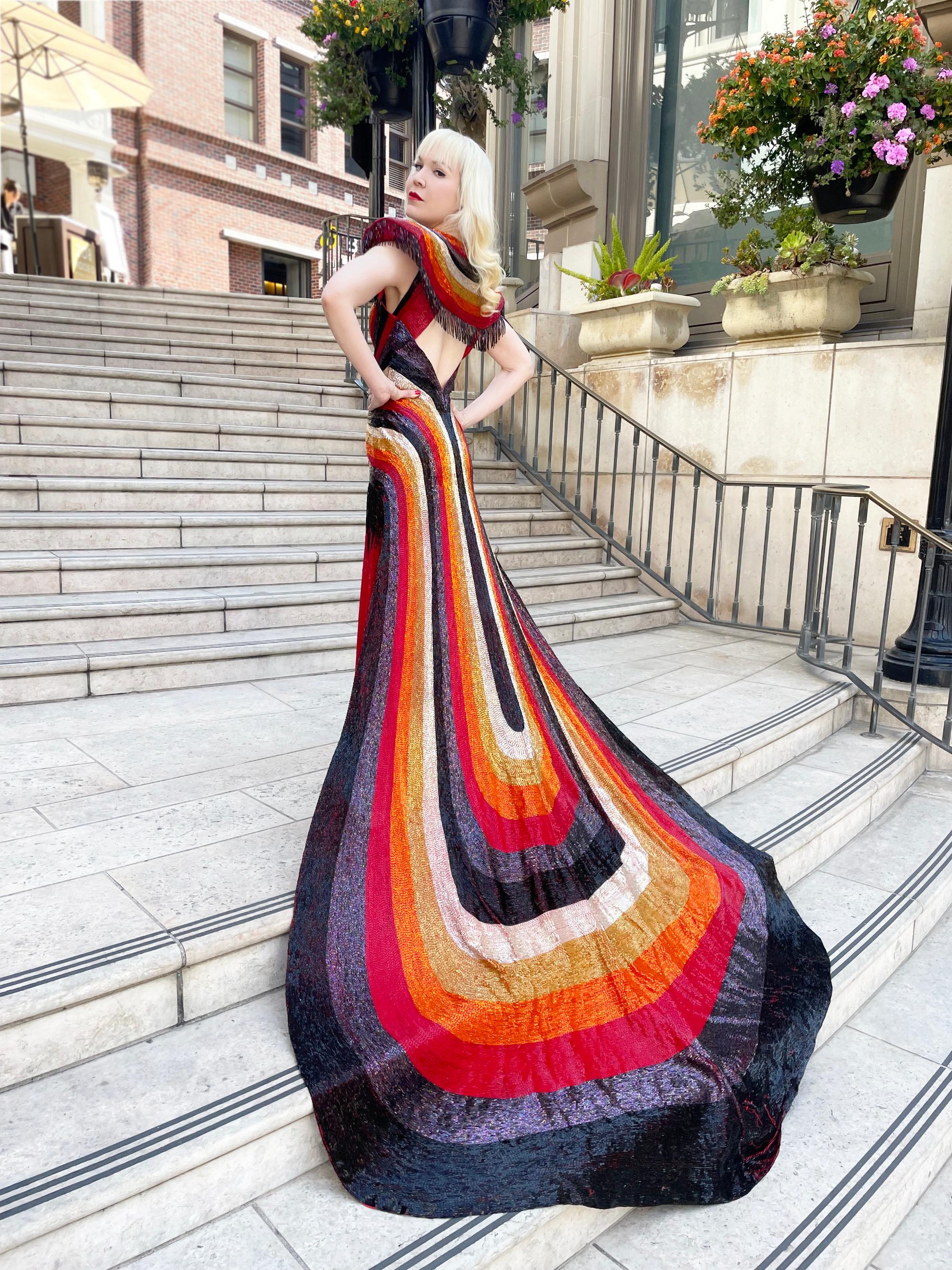 An unbelievable, museum worthy late 1970’s fully beaded hourglass trained glam rock custom couture gown ensemble by David Fernandez. Though not a household name, he is a beloved Puerto Rican fashion designer who is known for his complex beadwork and