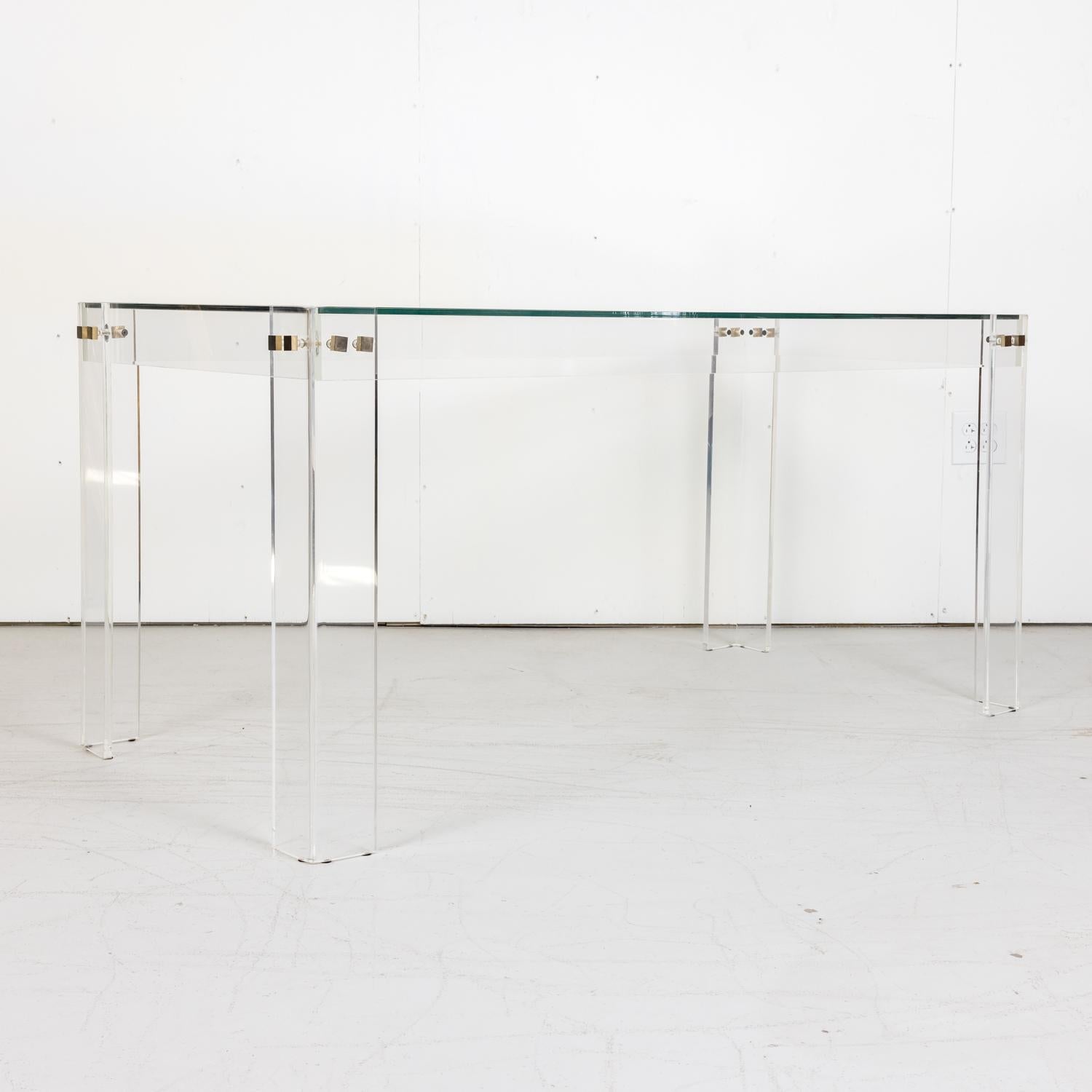 A fabulous vintage 1970s French Acrylic and glass top desk or console table having square brass fasteners. Could also be used as a dining table.

Dimensions:
H - 29