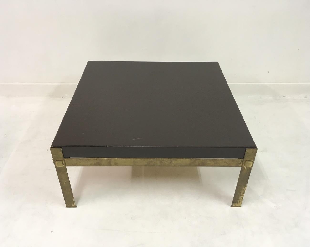A leather topped coffee table
Patinated brass base
French
1970s.
  