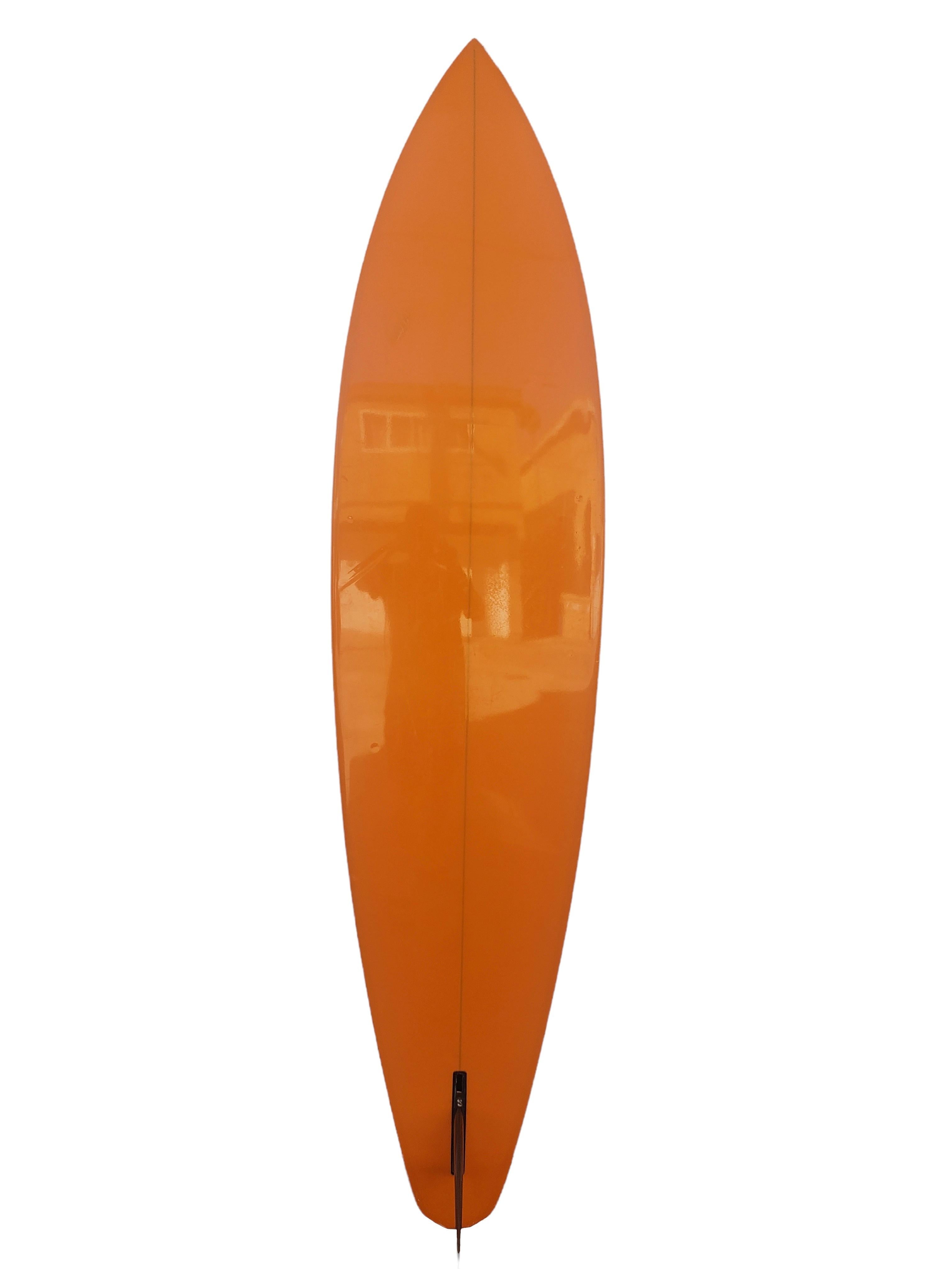 Early-mid 1970s Vintage Gerry Lopez model Lightning surfboard. Features a unique diamond tail shape design with gorgeous orange tint, black lightning bolt with matching pinstriping. A magnificent well preserved Gerry Lopez surfboard made under the