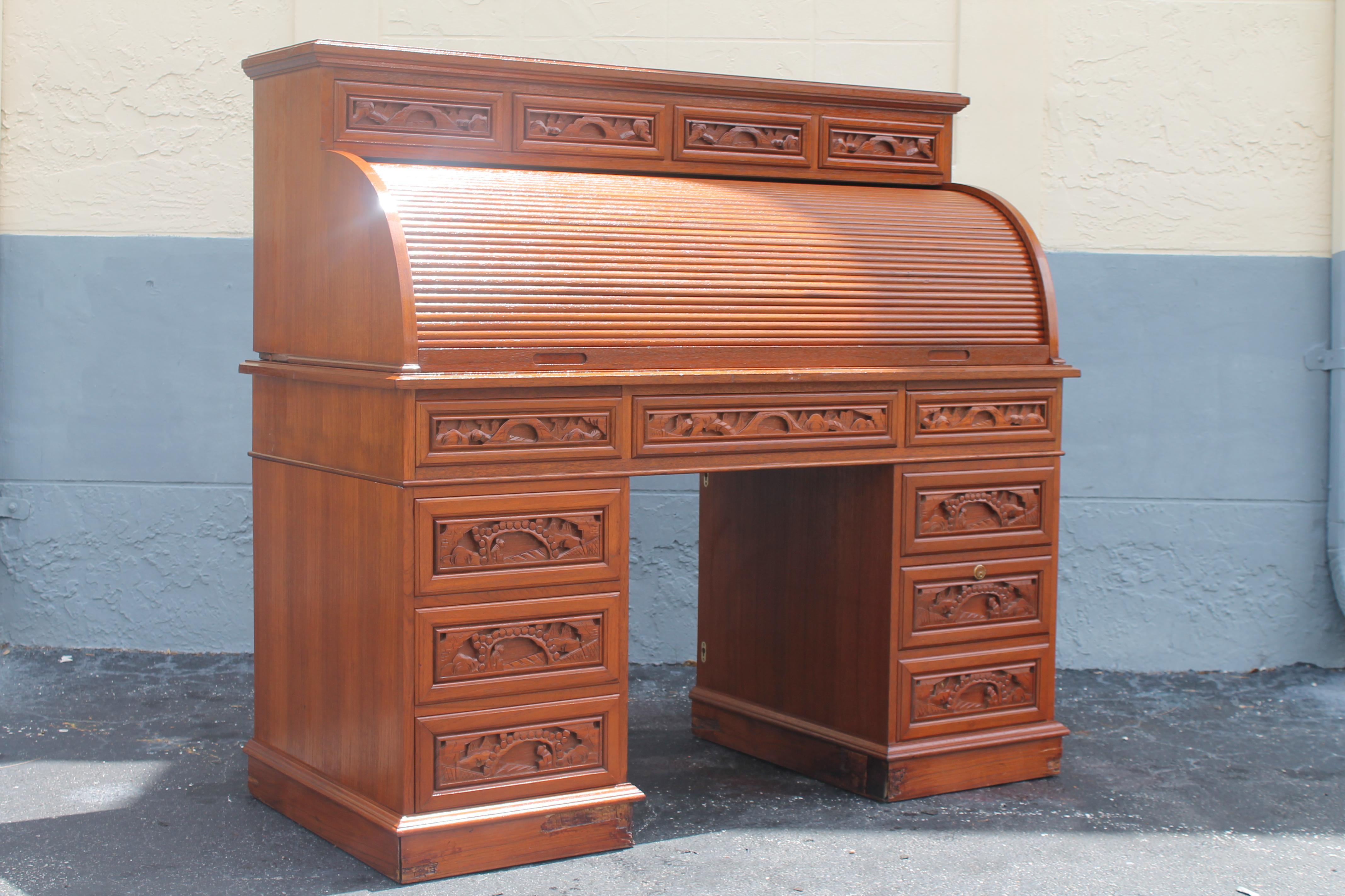 Beautiful Vintage Mid Century 1970's Grand Rolltop Writing Desk with Asian Flair. Beautifully carved. will convert to a standard writing desk by taking off the top rolltop portion. Stunning piece with all kinds of storage.