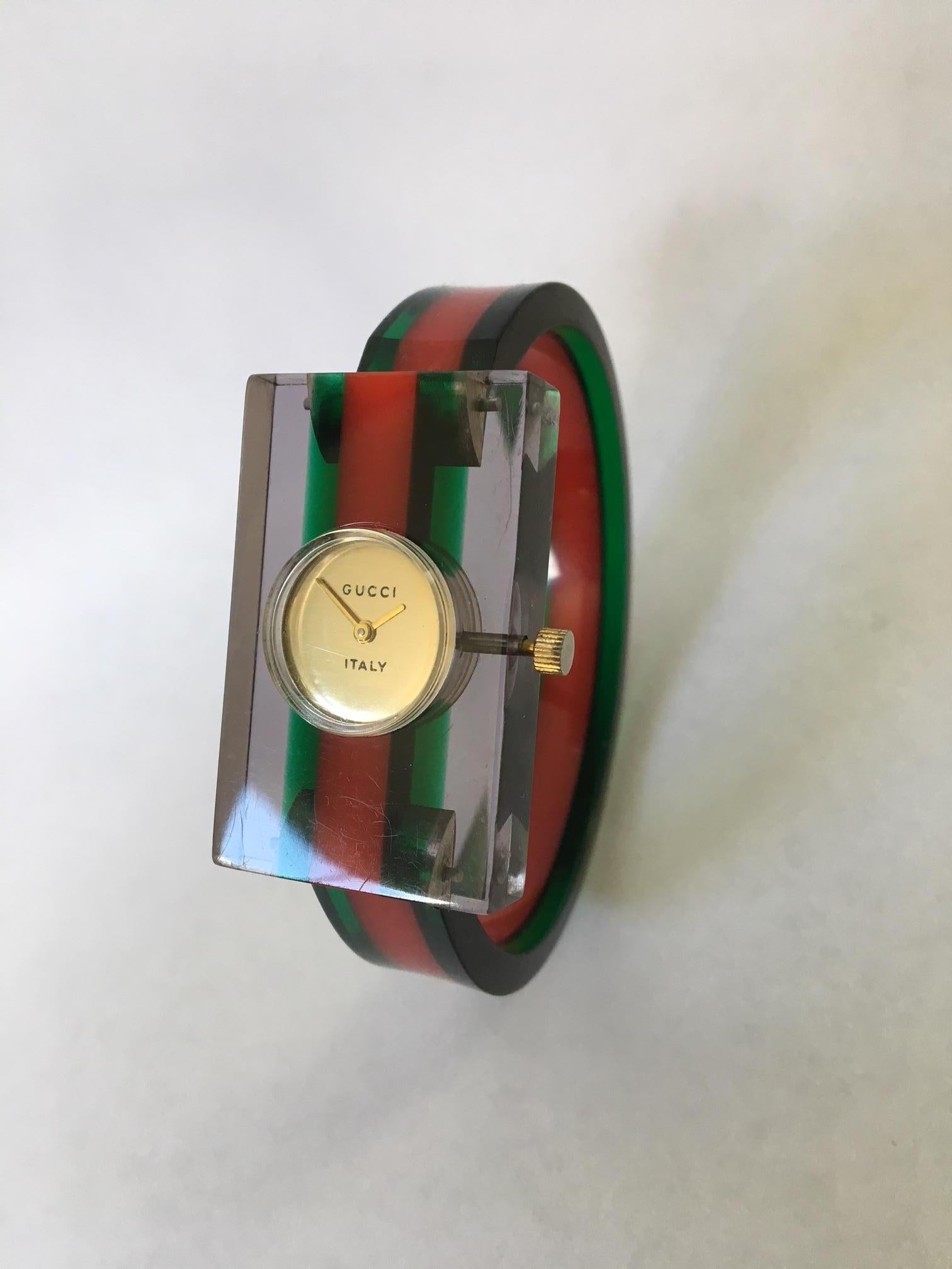 Vintage 1970's Gucci lucite and bakelite watch in the iconic red and green stripes. Condition is excellent. Keeps time perfectly.