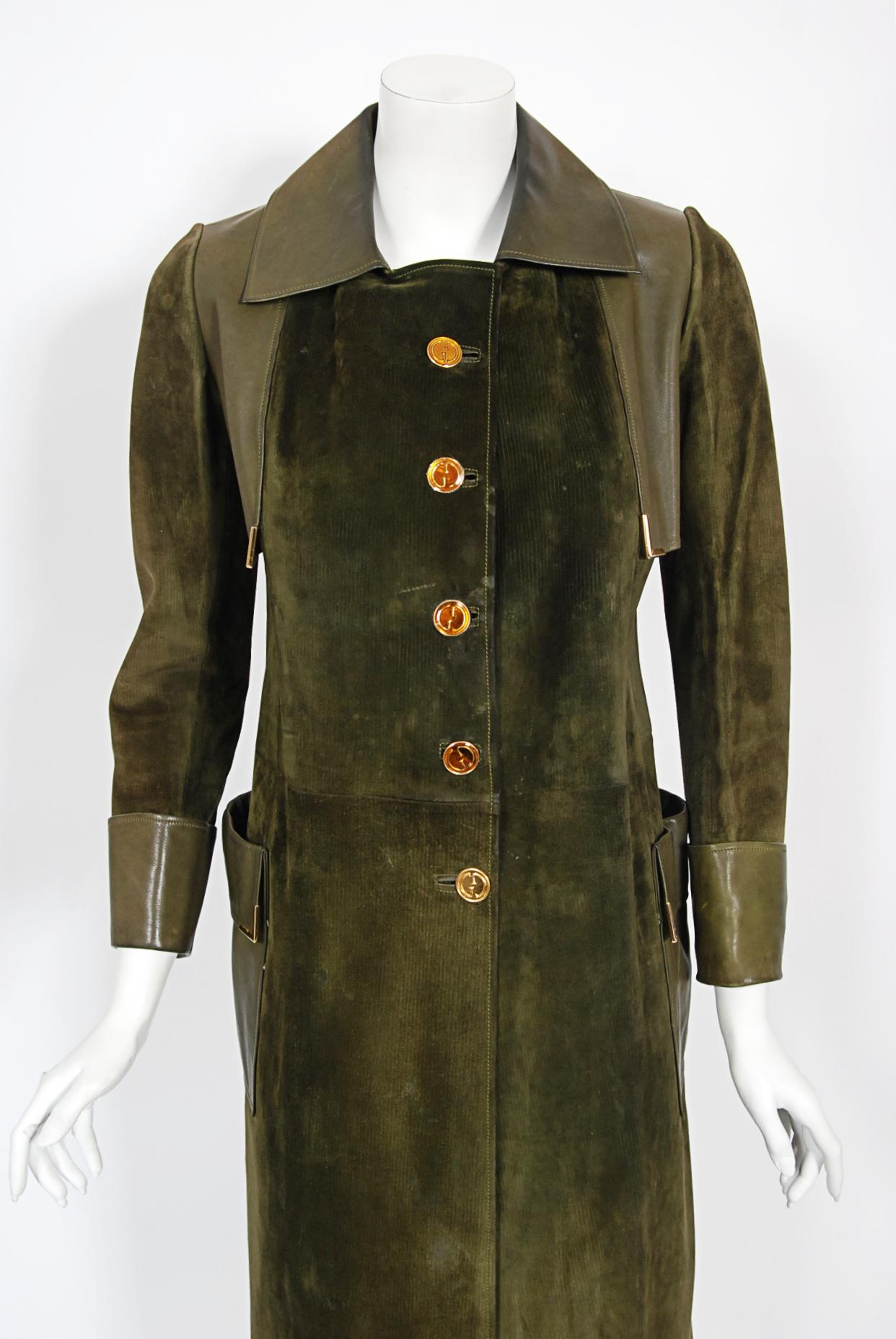 A spectacular early 1970's Gucci trench coat entirely crafted in the highest quality olive-green leather and suede. This color is sensational! Earlier Gucci garments are very hard to come by and this garment is a statement piece. The jacket is