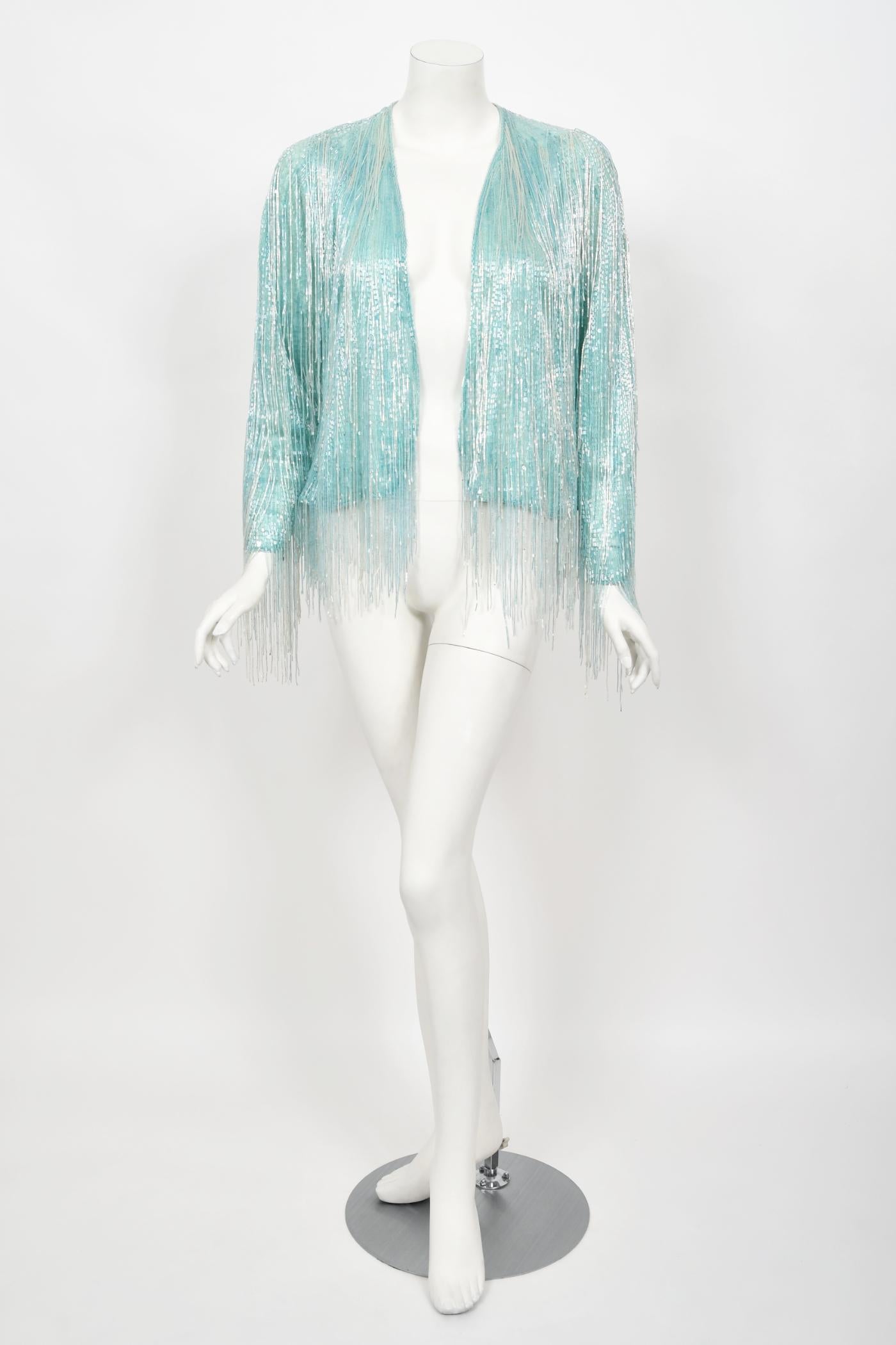 A truly epic and instantly recognizable Halston couture ice blue semi-sheer beaded silk cardigan jacket dating back to the mid 1970's. Halston revolutionized the way women dress and is one of the few designers, alongside Claire McCardell and Norman