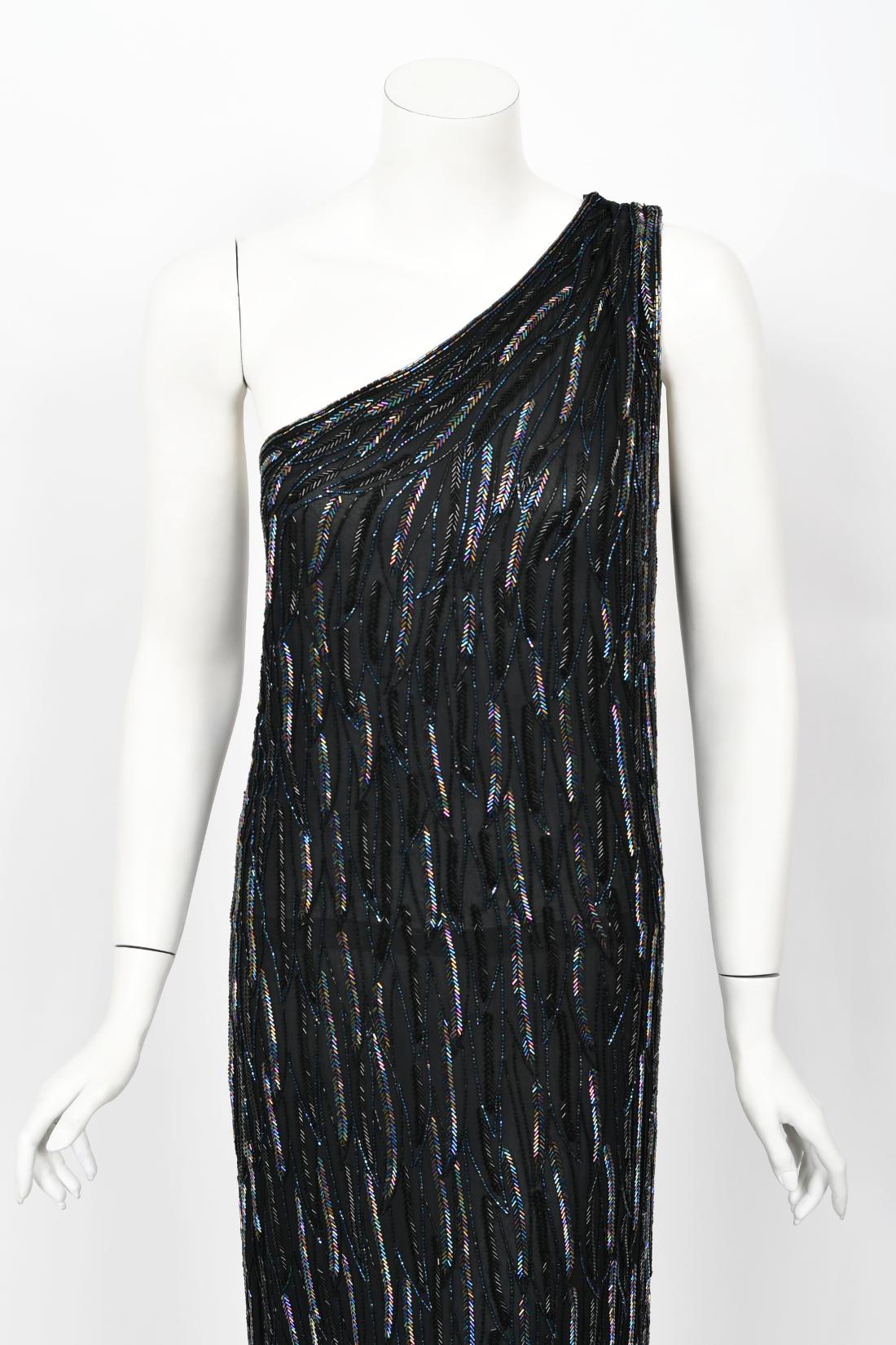 An absolutely stunning and highly desirable Halston couture fully beaded silk one-shoulder dress dating back to the mid 1970's. Halston revolutionized the way women dress and is one of the few designers, alongside Claire McCardell and Norman Norell,