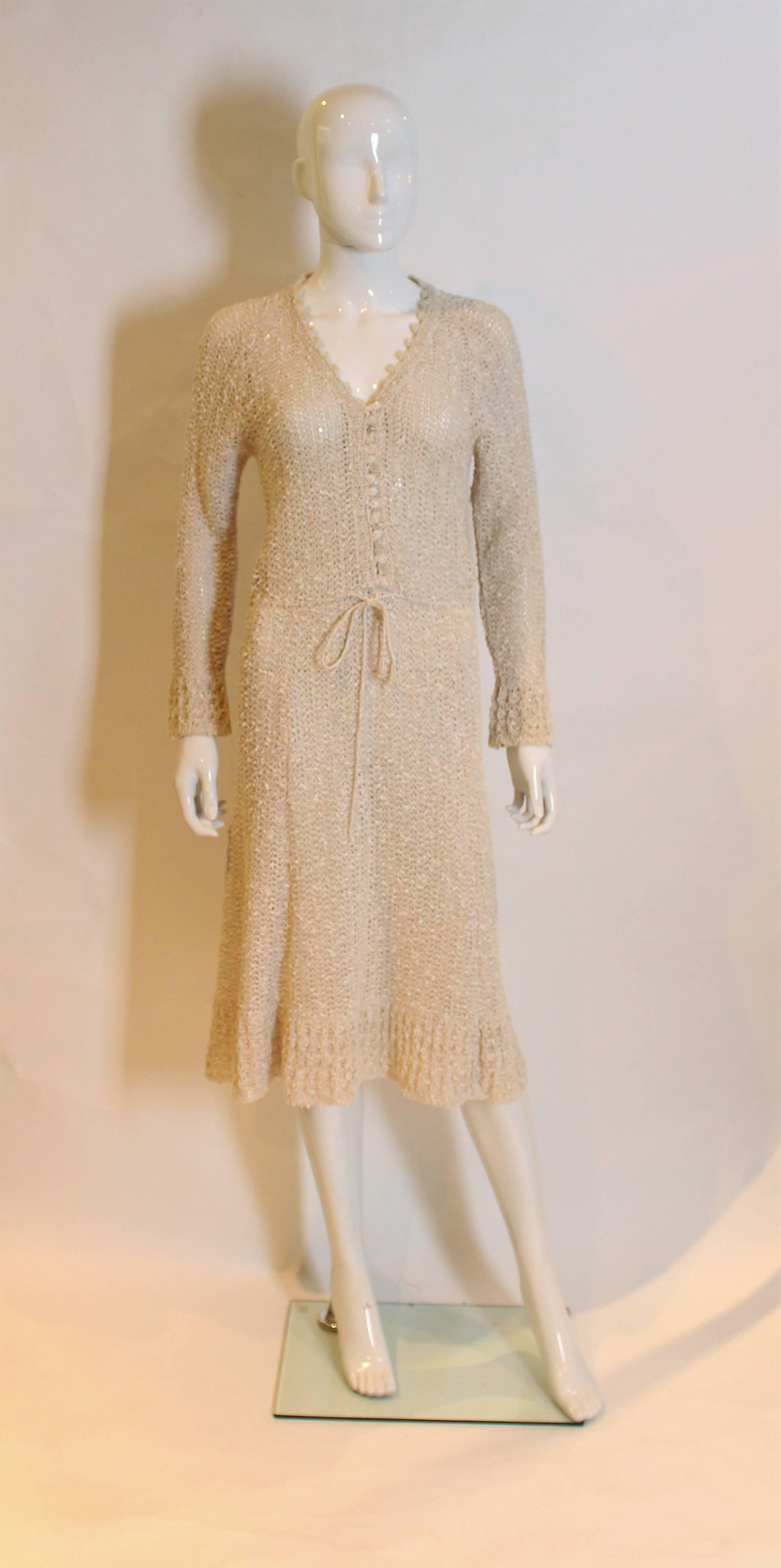 this is a lovey handloomed Irish linen crochet dress.It has a v neckline, long sleeves, and buttons to waist.The waist has drawstring and a flared skirt.
