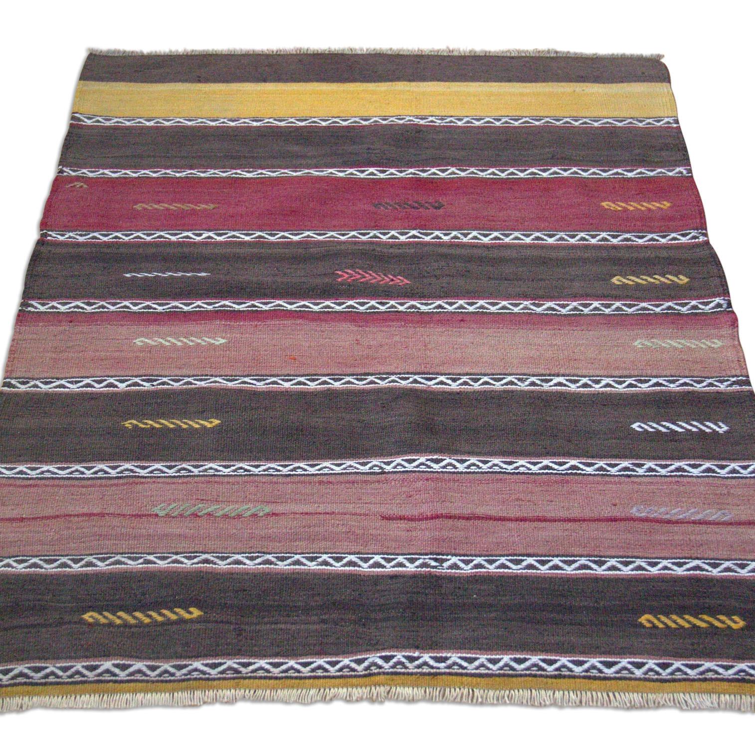 From one of the villages surrounding the city of Aksaray in Central Anatolia of Turkey, this Kilim rug was handwoven in the mid-20th century for use as a dowry piece. Smaller in size, these types of rugs were woven to fill small spaces and other