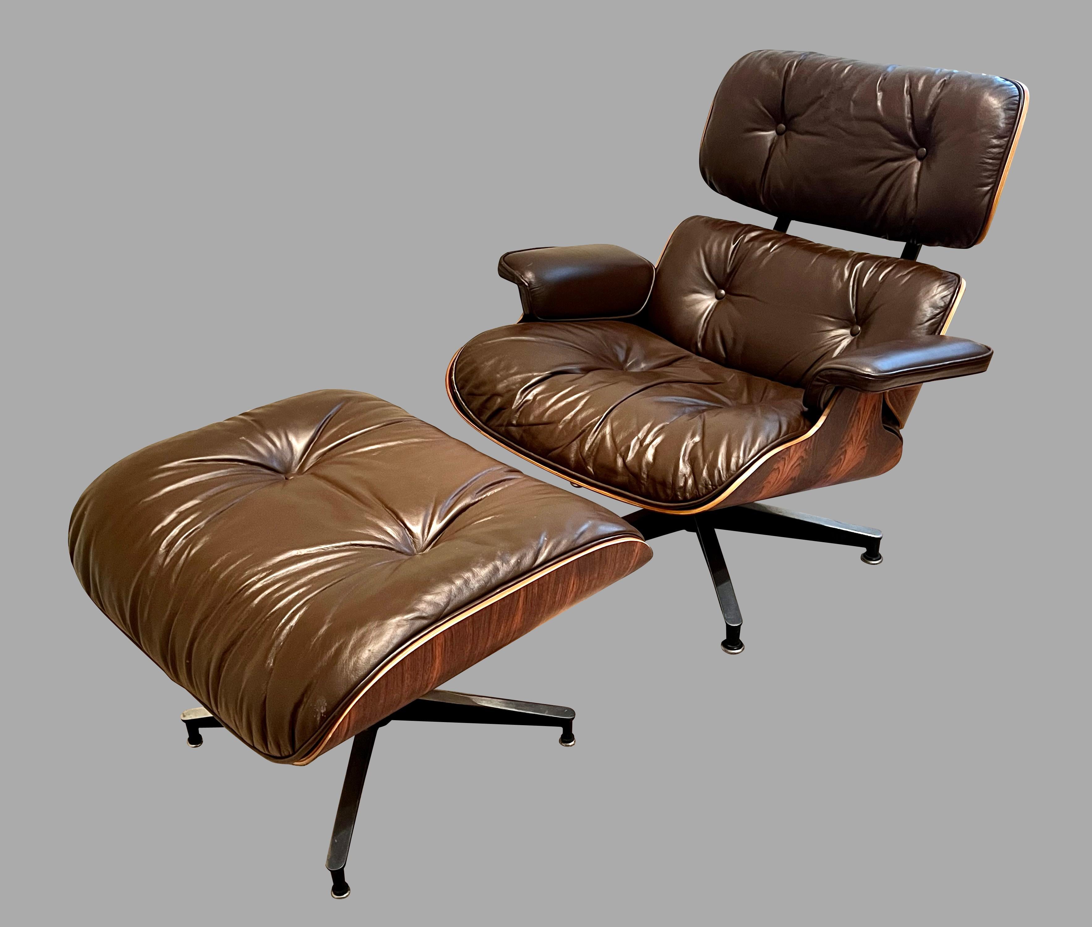 A fully labeled example of the classic Charles Eames brown leather and laminated rosewood model 670 lounge chair with matching model 671 ottoman. The iconic Eames 670 chair has been in continual production since the late 1950's. This chair and