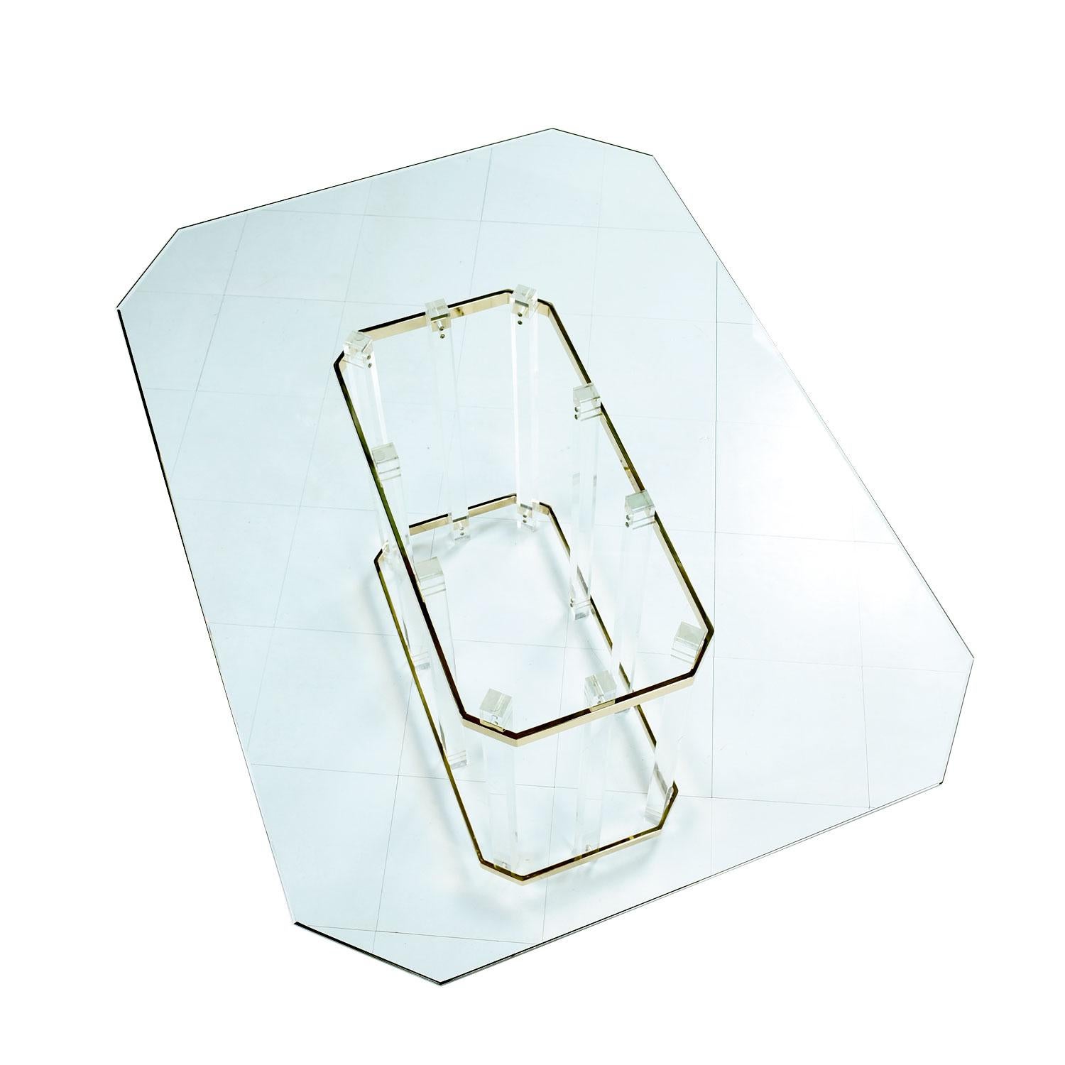 Vintage 1980s Charles Hollis Jones style Lucite and brass dining table with beveled glass top. The geometric beveled glass top creates a silhouette mimicking the dynamic angles and form of the table base. Vertical acrylic architectural pillars