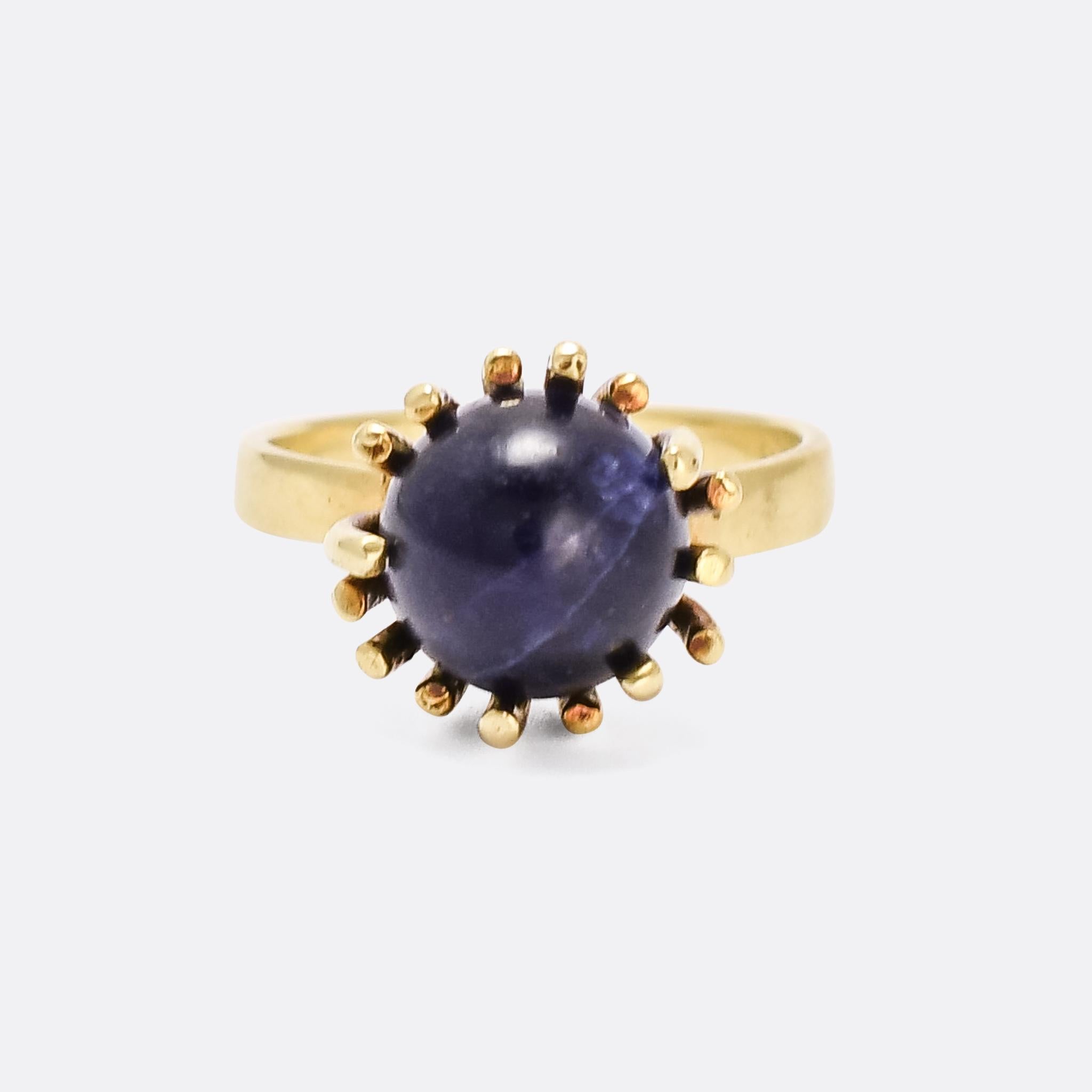 A cool 1970s solitaire ring with five interchangeable gemstone orbs. The stones can be swapped in and out by way of a clever mechanism: squeezing the shoulders together moves one of the prongs out, falling back in place when worn to secure the
