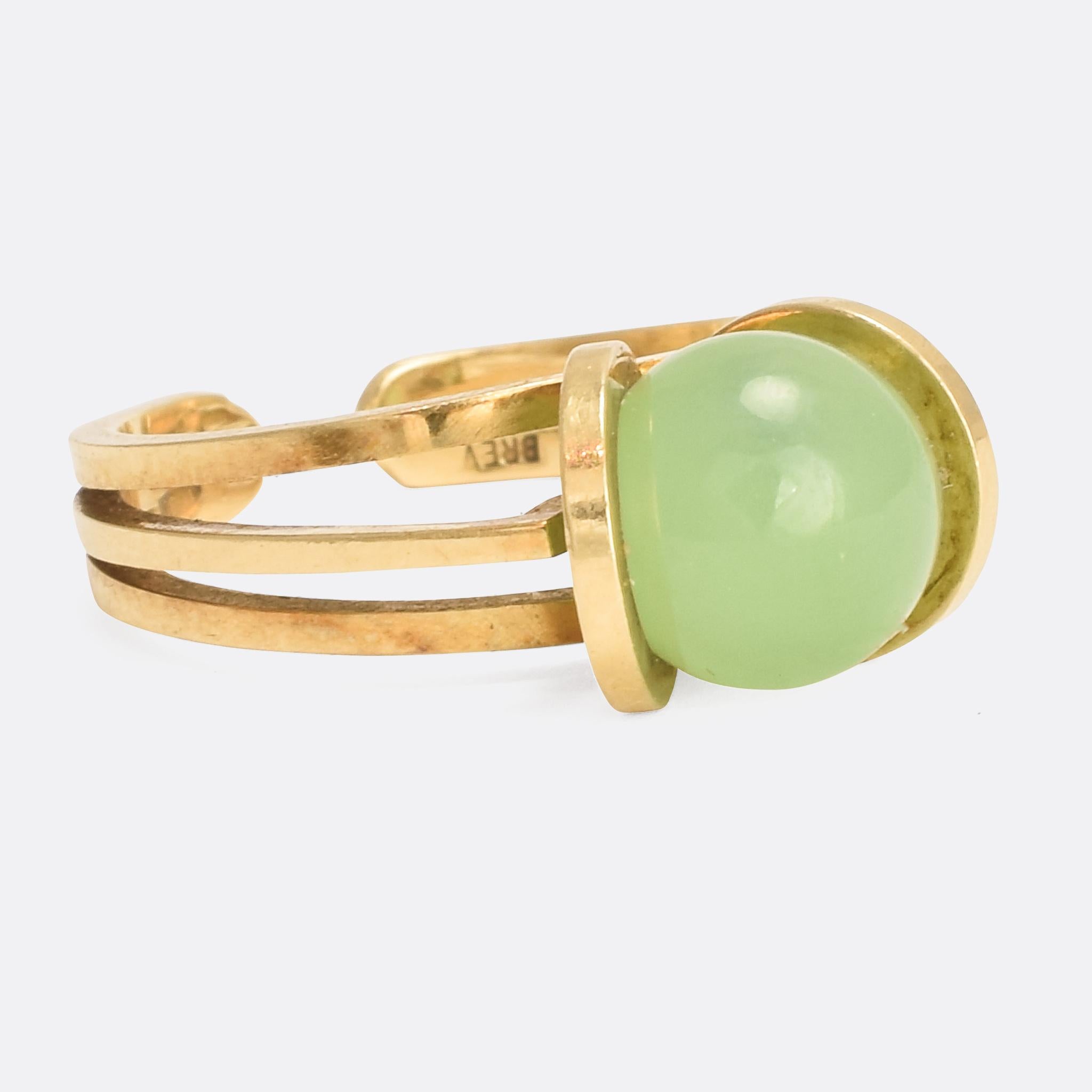 A wonderful vintage ring with eight interchangable semi-precious stones. The ring mount is crafted in 18k gold with striking 1970s styling, and the eight stones are shaped into spheres that snap in and out of the two circles at the head. It's