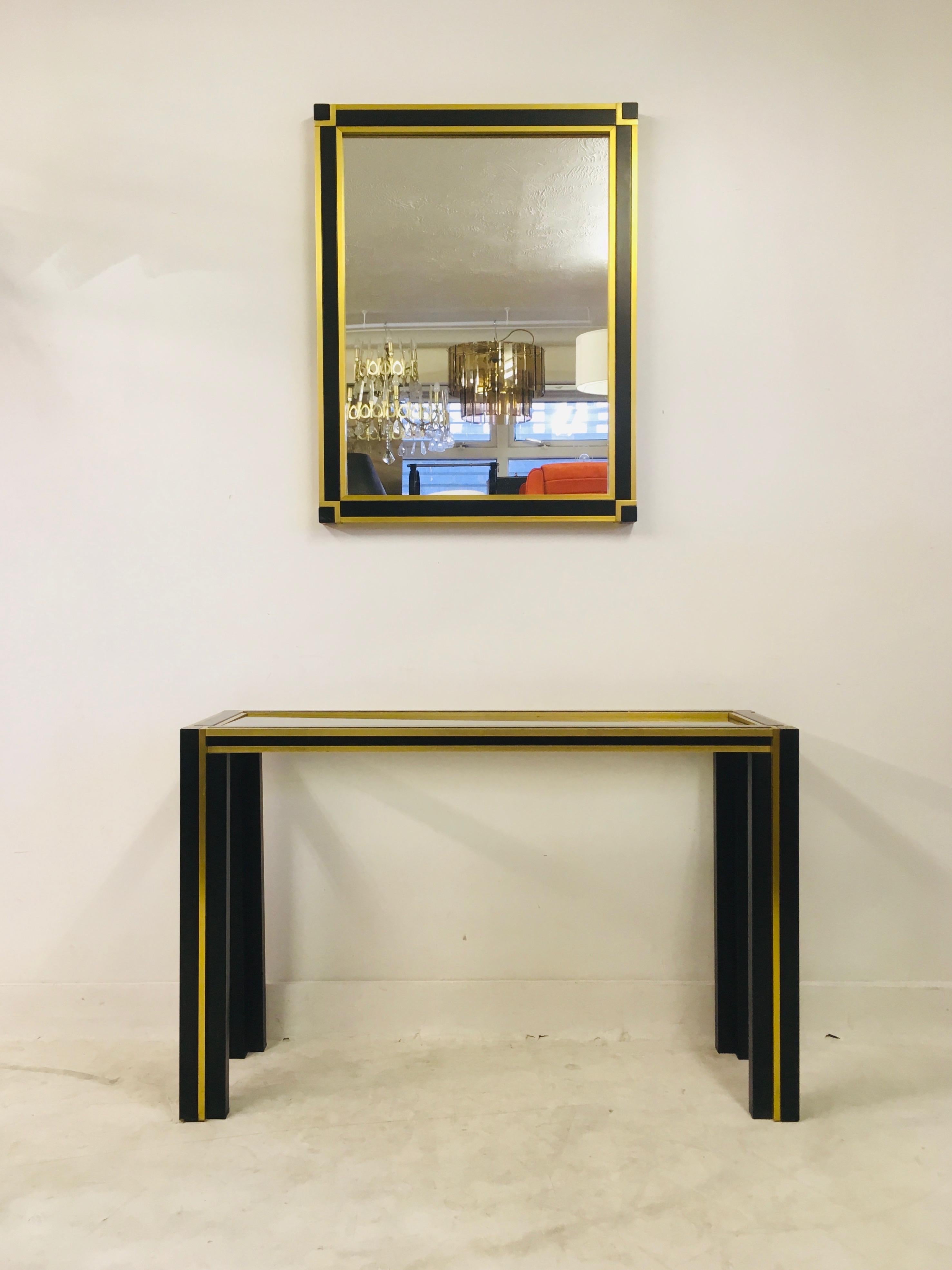 Vintage console table and mirror

Black metal frame

Brass banding

Mirror measures 90 x 70cm

Italy, 1970s.
