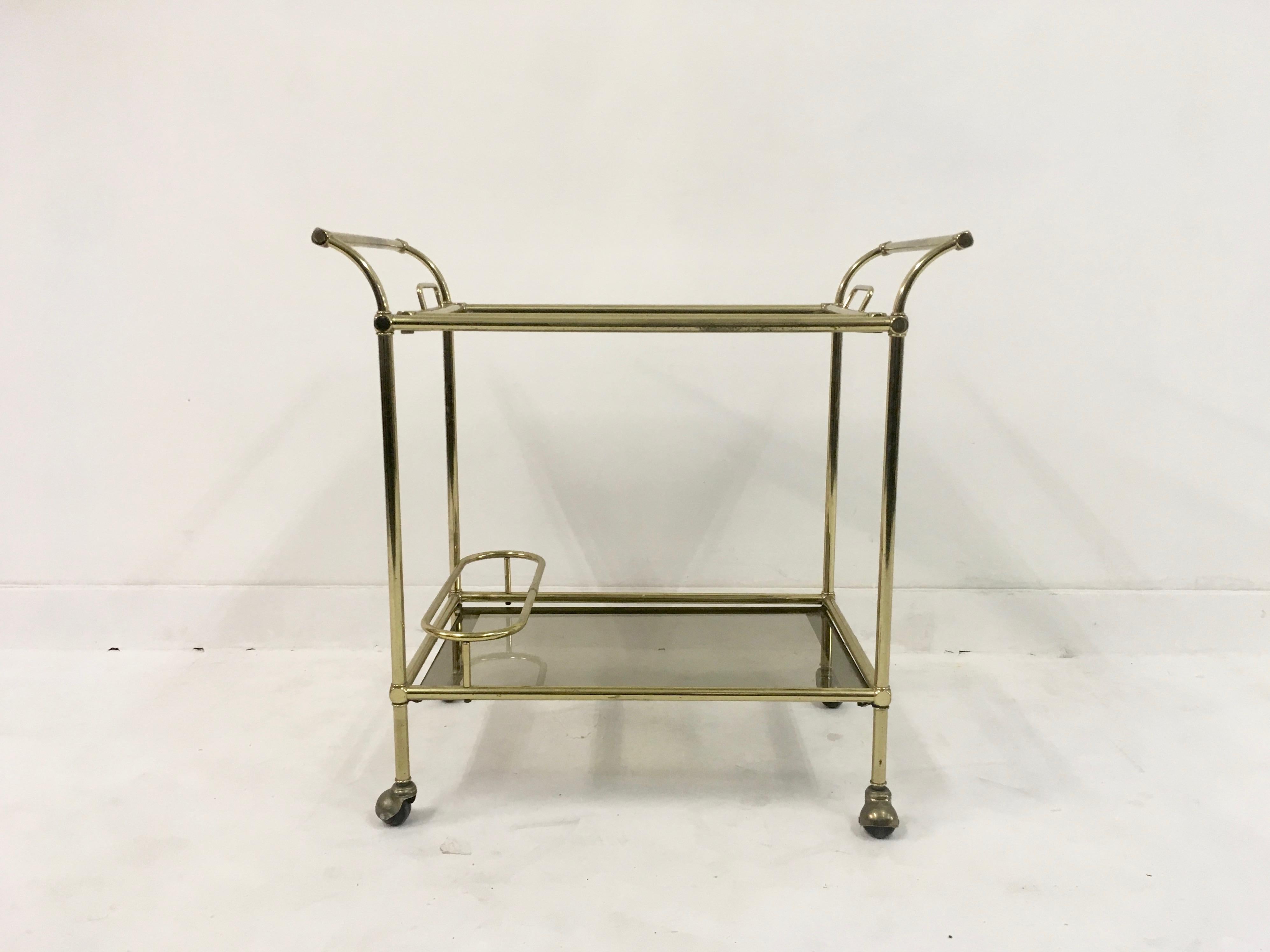 Drinks trolley or bar cart

Brass frame

Removable tray

Silver edged glass

Chip to corner of bottom shelf

Italy, 1970s.